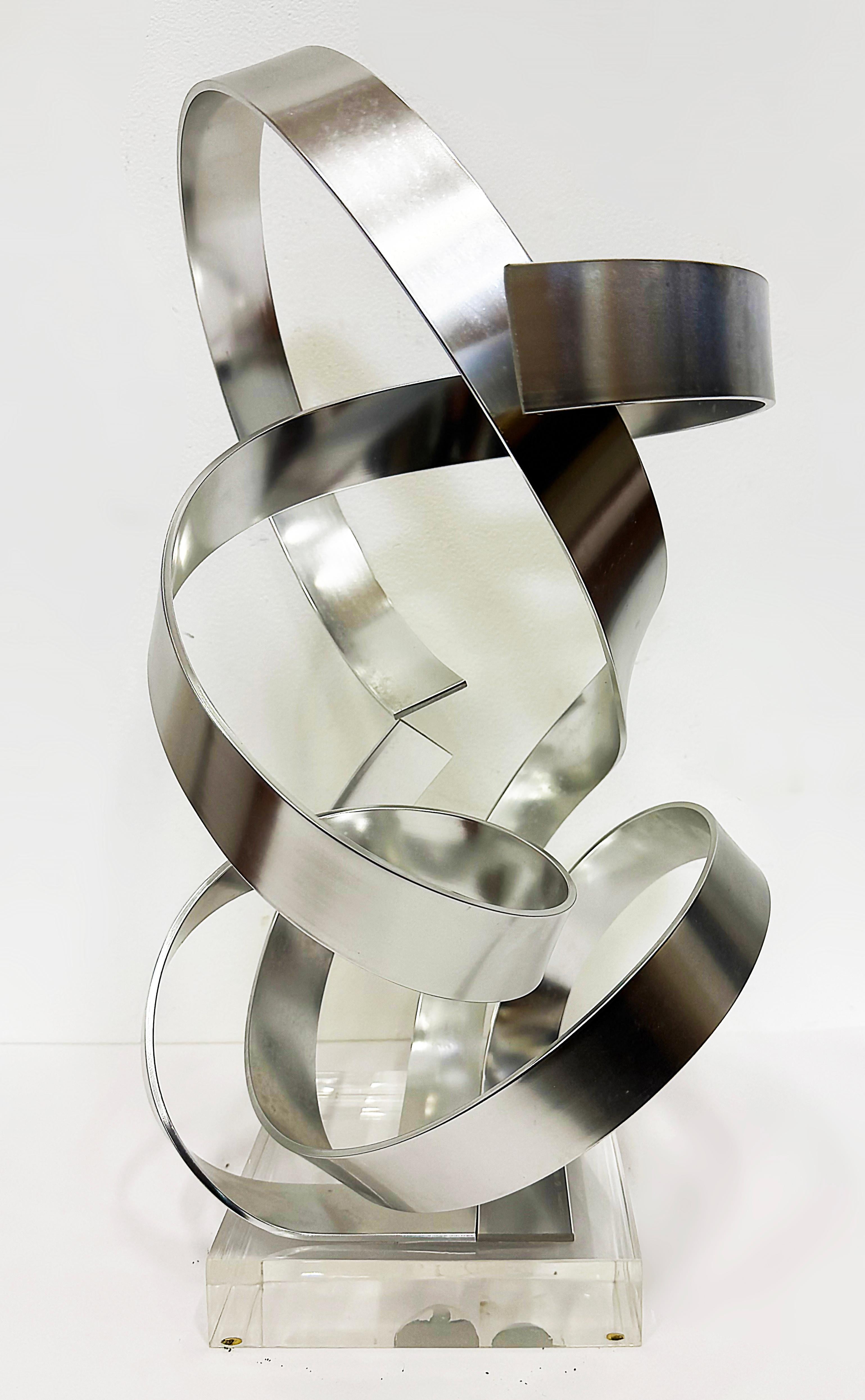 Dan Murphy 1985 Abstract Ribbon Sculpture on a Lucite Base

Offered for sale is and unusually intricate abstract Ribbon sculpture by
Dan Murphy.  The sculpture is signed and dated 1985 on the Lucite base.

 13
