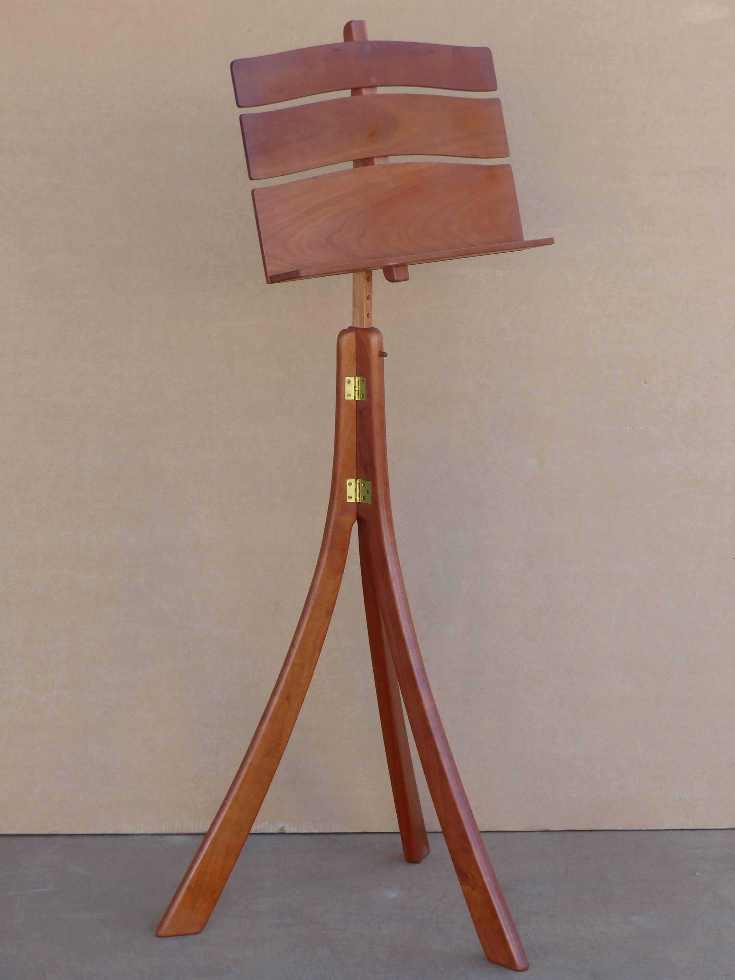 Adjustable walnut music stand with folding tripod base and removable top for easy transport. 40.25