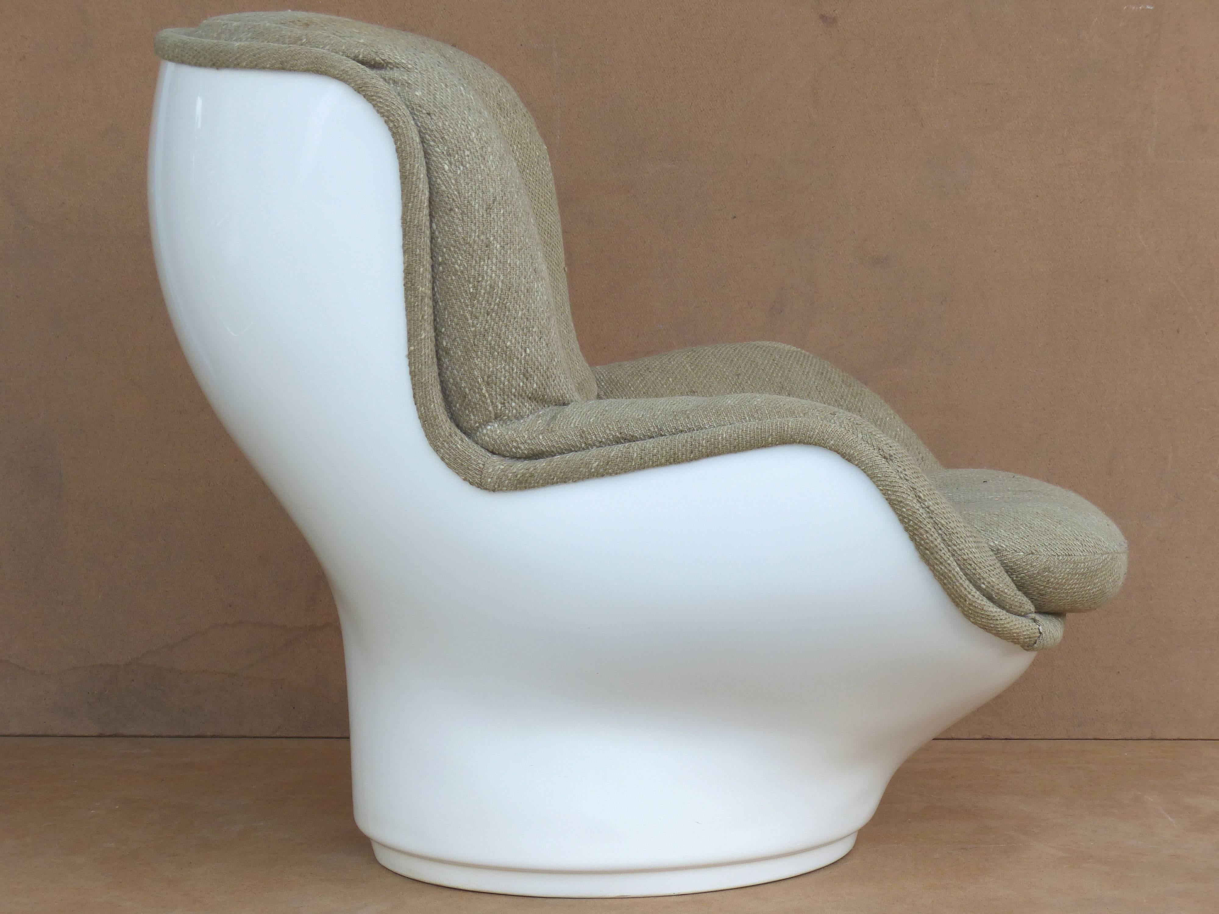 

 This iconic Mid-Century Modern design by Michel Cadestin from the 1960s was manufactured by Airbourne International in France. Referred to as the "Karate" chair, it is made of a fiberglass shell with upholstered seat and ottoman. A
