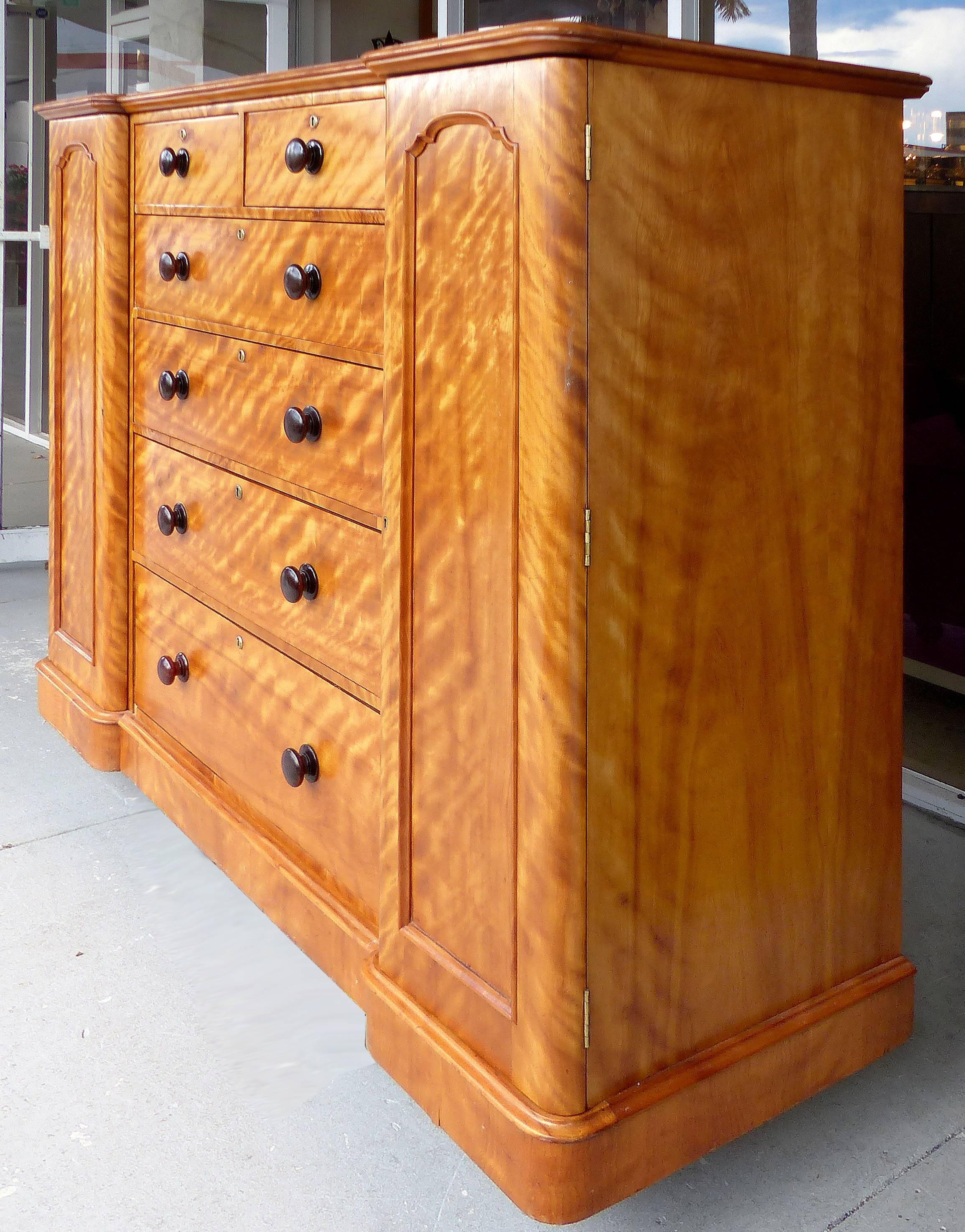 19th Century Tall Maple Biedermeier Dresser

A 19th century Biedermeier tall maple dresser with six drawers and two-side compartments. The finish is vibrant and accented by dark turned wood knobs. The cabinet does show wear and minor losses