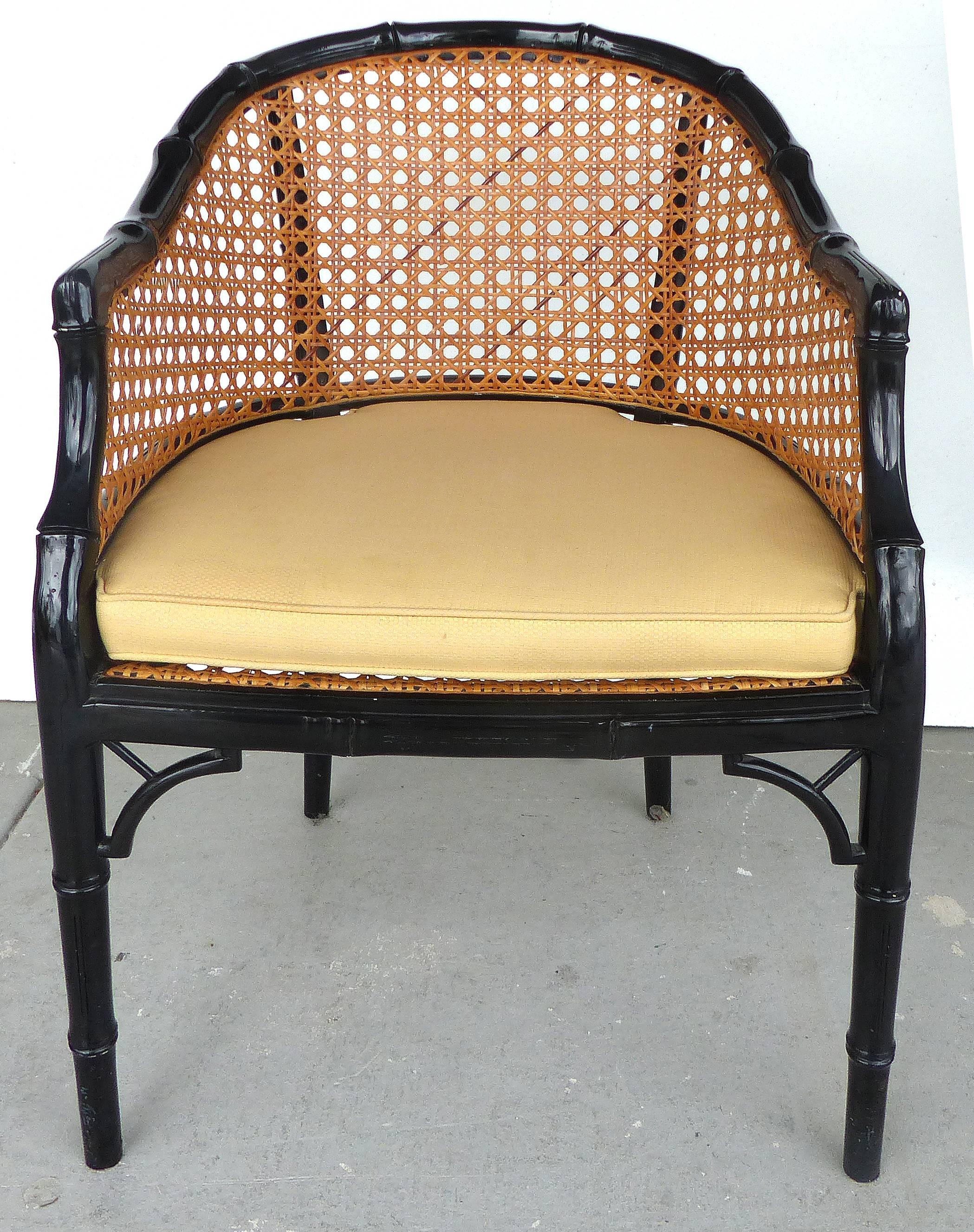 
 

A pair of gloss lacquered carved faux-bamboo wood barrel-back chairs with inset over-scale woven cane panels. The fitted cushions are reversable and in very nice condition. Measures: Arm 33" H; Seat 15.5" H w/o cushion and 18"