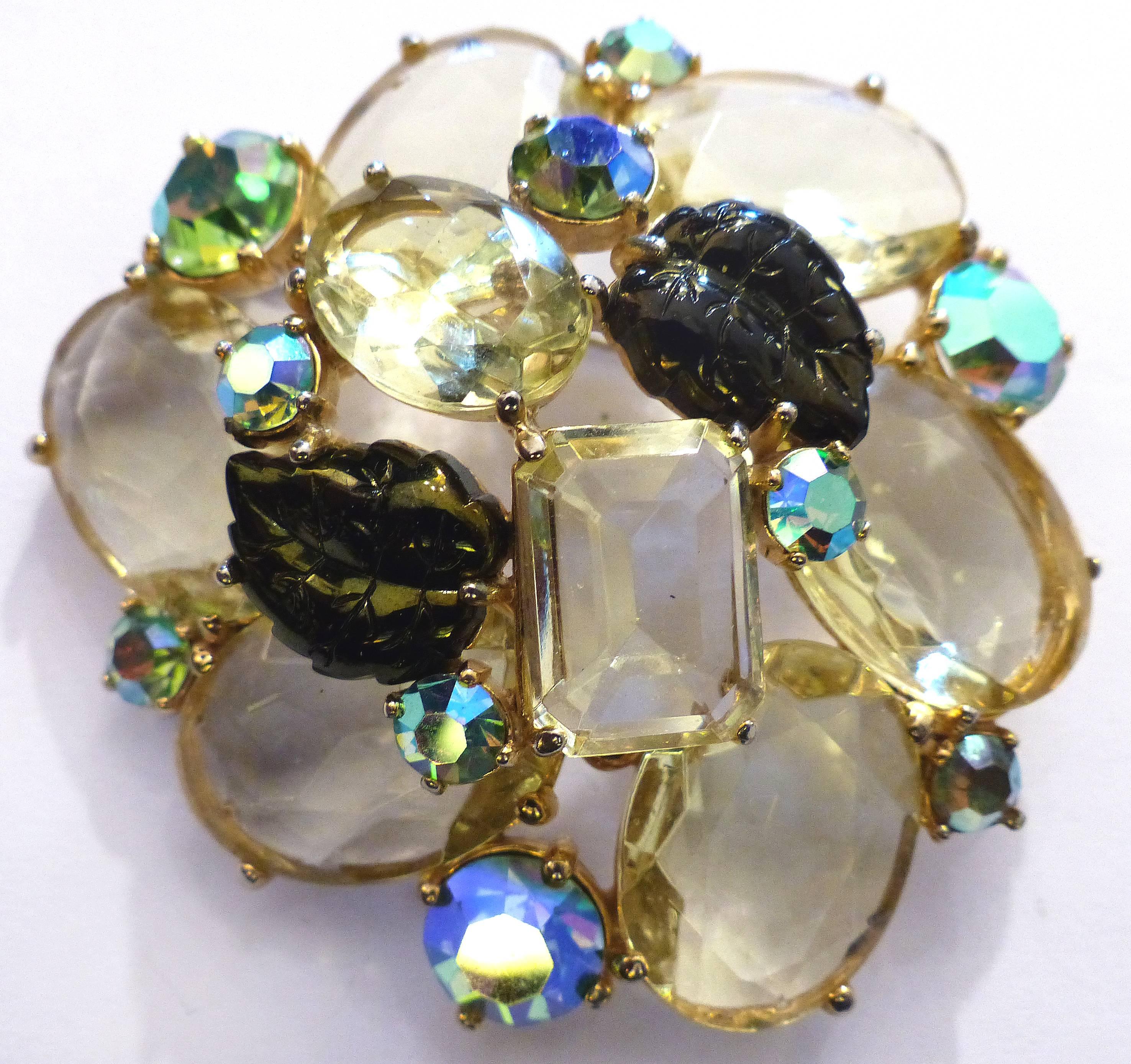 1950s Elsa Schiaparelli Brooch & Earrings Set with Swarovski Aurora Crystals

$1,895.00.

 

A 1950s Elsa Schiaparelli brooch and earring set that is a fine example of Schiaparelli's work. Set with warm tone crystal stones and Swarovski Aurora