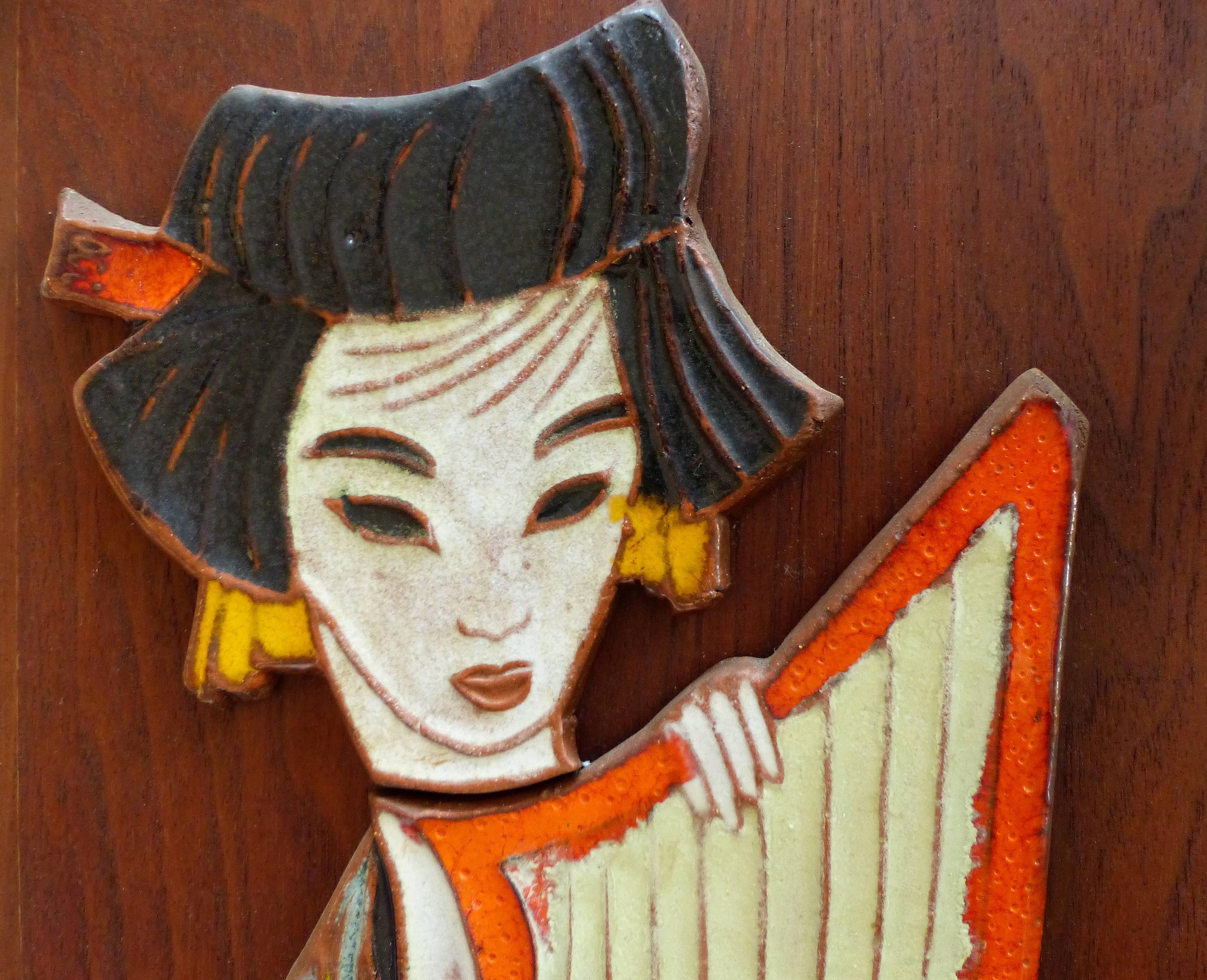 A pair of Mid-Century Modern glazed ceramic wall plaques with a geisha theme by the noted Mid-Century ceramicist Harris Strong. Plaques have hangers provided. The plaques no longer retain the original maker's label but are well know as Strong’s.