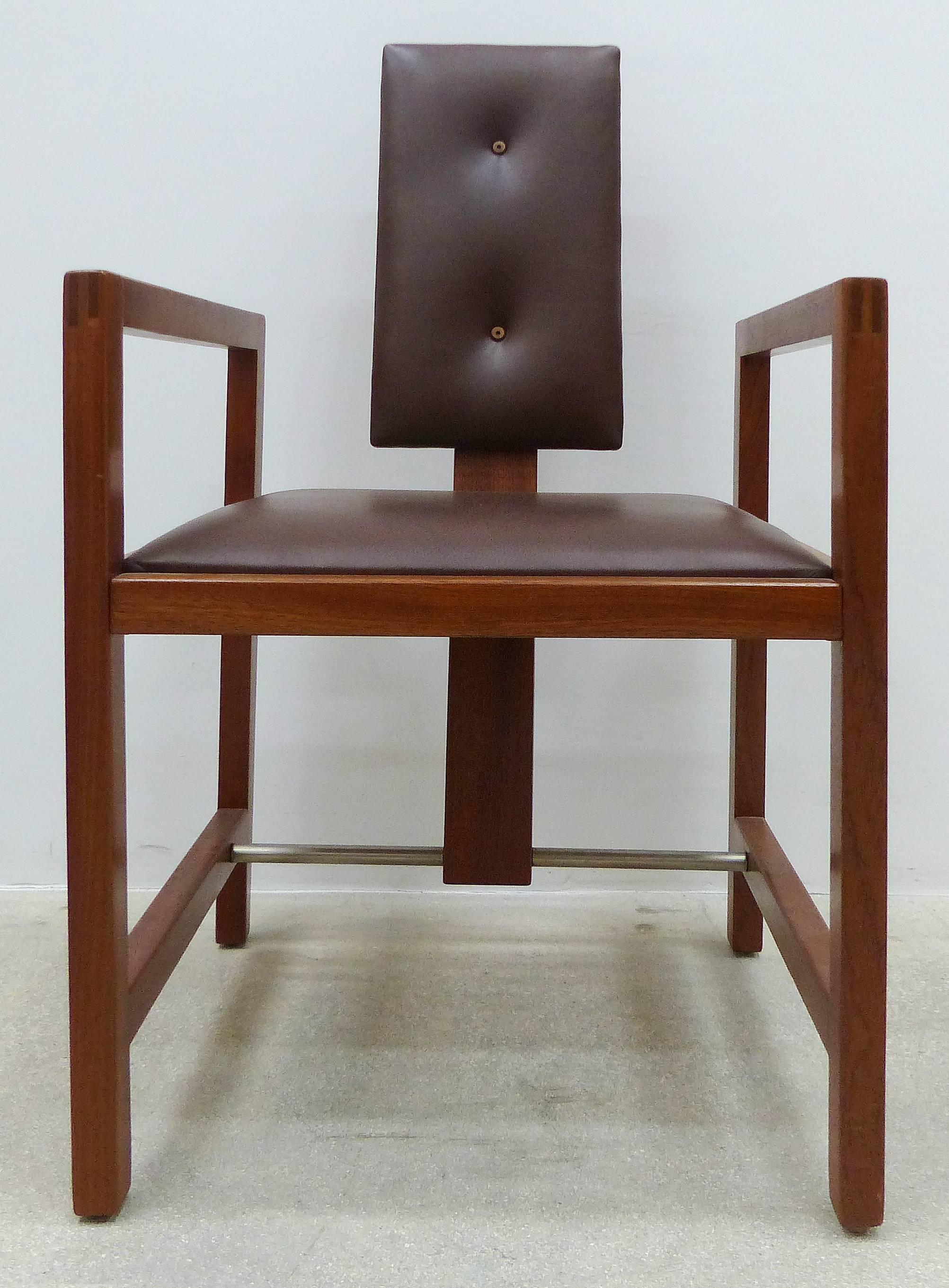 A set of four French Art Deco armchairs designed and made by Andre Sornay (1902-2000) in Lyon, France. Constructed of solid mahogany with the arms connected to the front and rear legs with an exposed finger joint. The back splat is ribbon mahogany