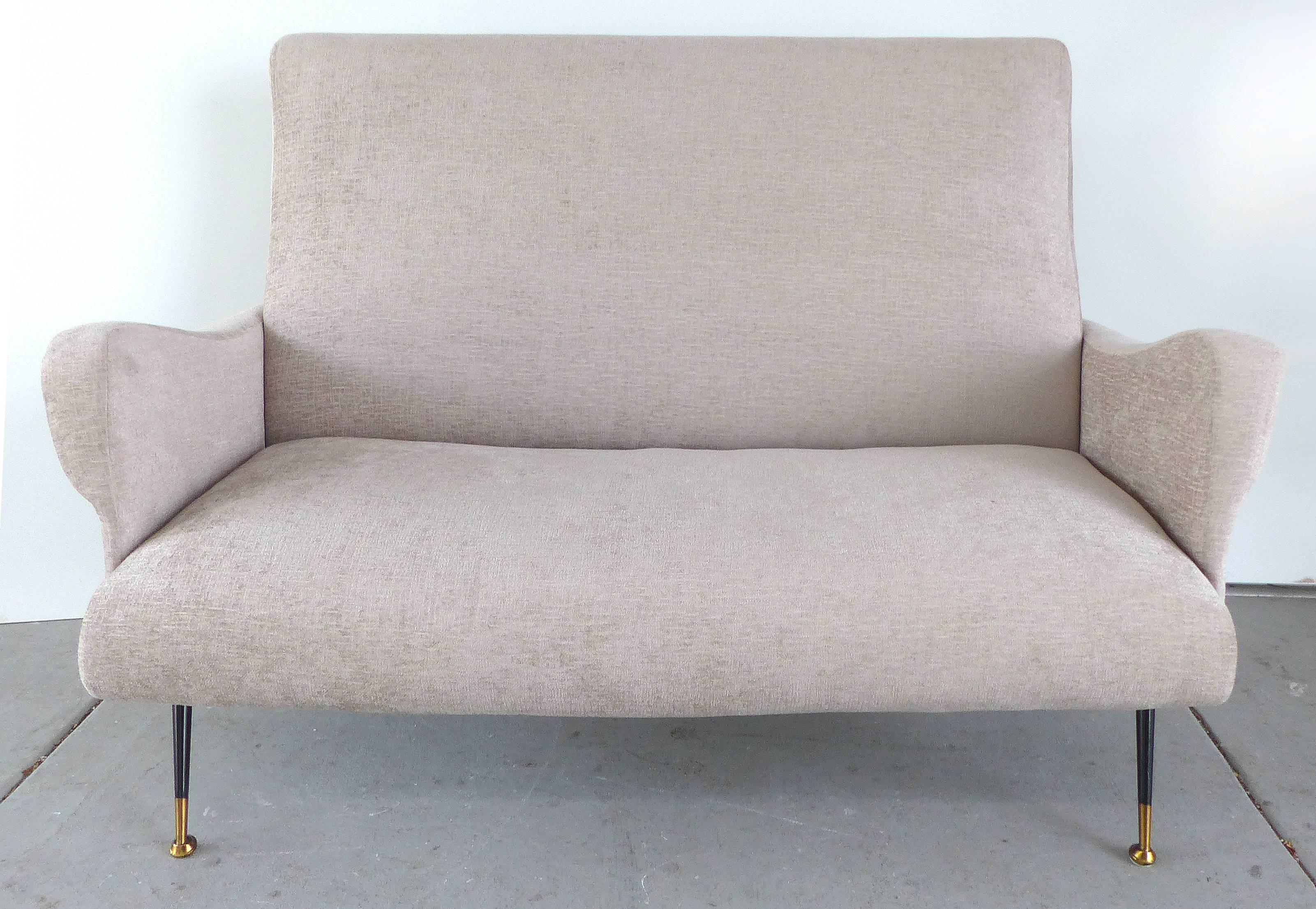 A Italian modern settee newly upholstered in a lightly textured chenille velvet, circa 1950s. This Classic settee is supported by splayed tapered metal legs fitted with brass feet. The arms sinuously curve and roll with lovely details.