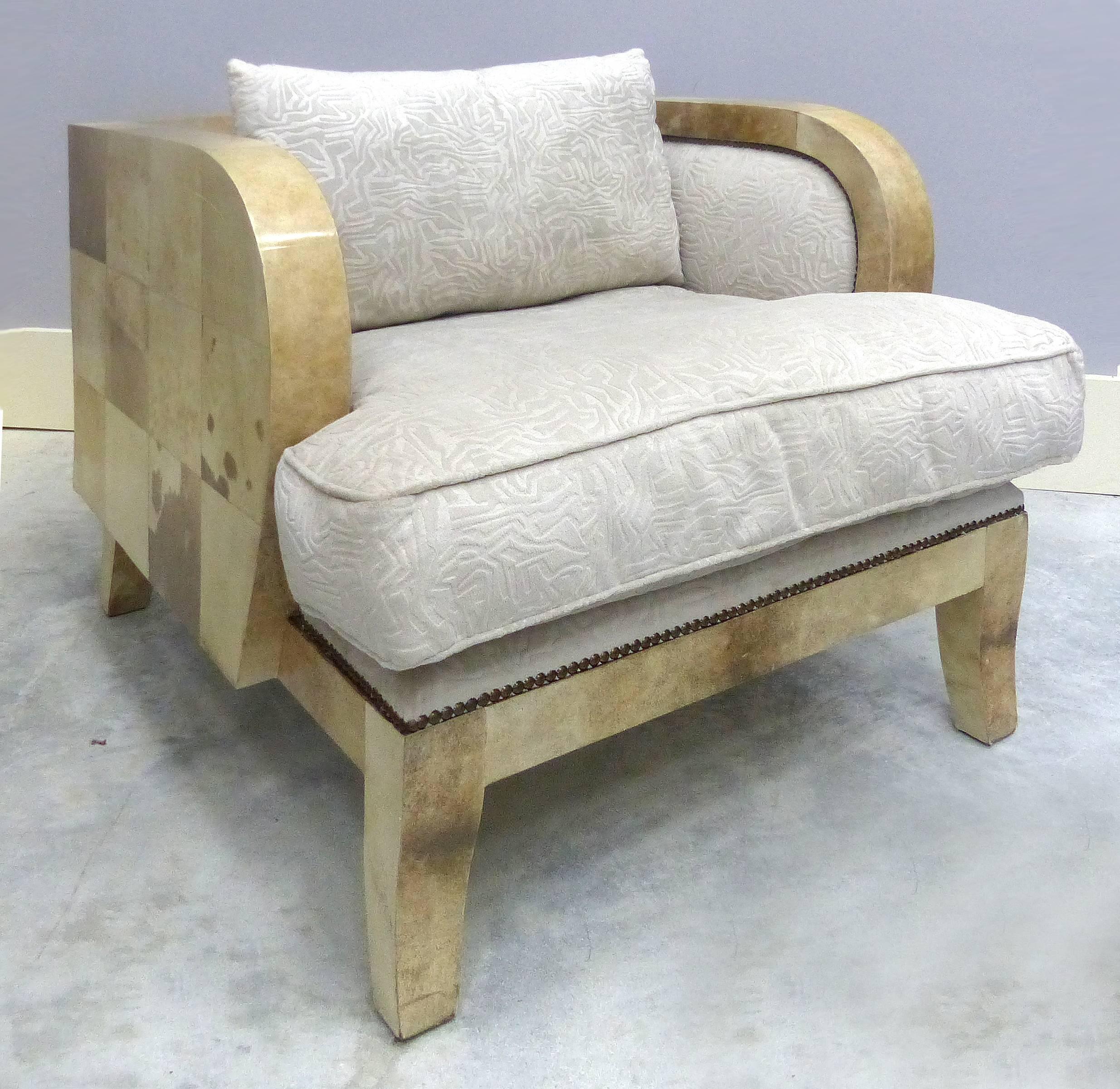 Art Deco Club Chairs Covered in Lacquered Goatskin

A comfortable pair of Art Deco club chairs covered in lacquered goatskin. Nicely upholstered in an off-white textured velvet fabric with brass nailheads. With loose seat and back cushions and