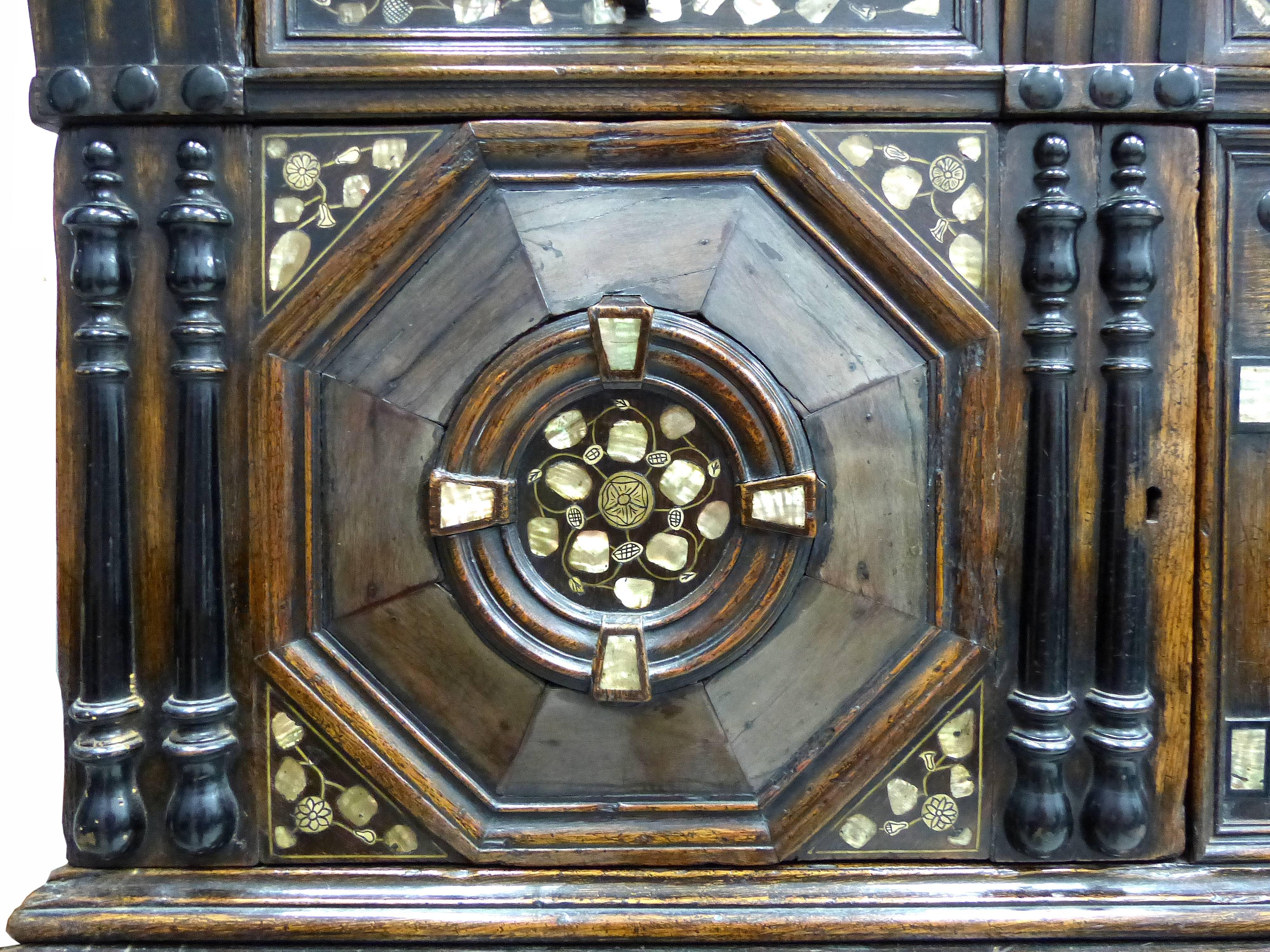 Restoration Charles II English Cabinet circa 1660-1685, Mother-of-Pearl Inlays

This is a Charles II oak chest on chest press with an overhanging cornice and a frieze drawer. Below are two octagon paneled cupboard doors flanking an arcaded central
