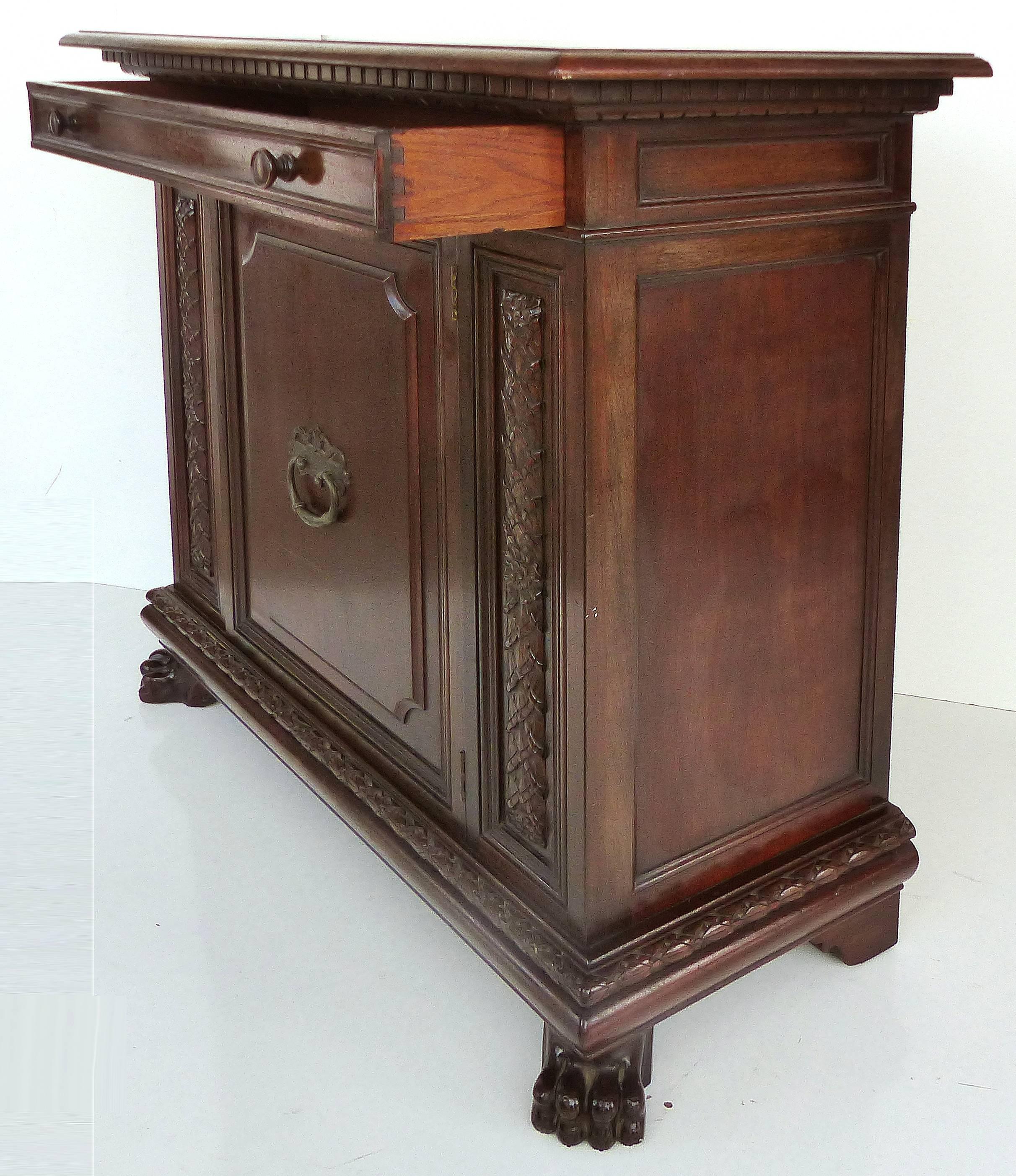 Renaissance Revival Mahogany Cabinet with Drawer, circa 1920

Offered is an American solid mahogany renaissance revival cabinet, circa 1920 with one drawer with nice dovetailing and two knob handles above a door which opens to reveal two open