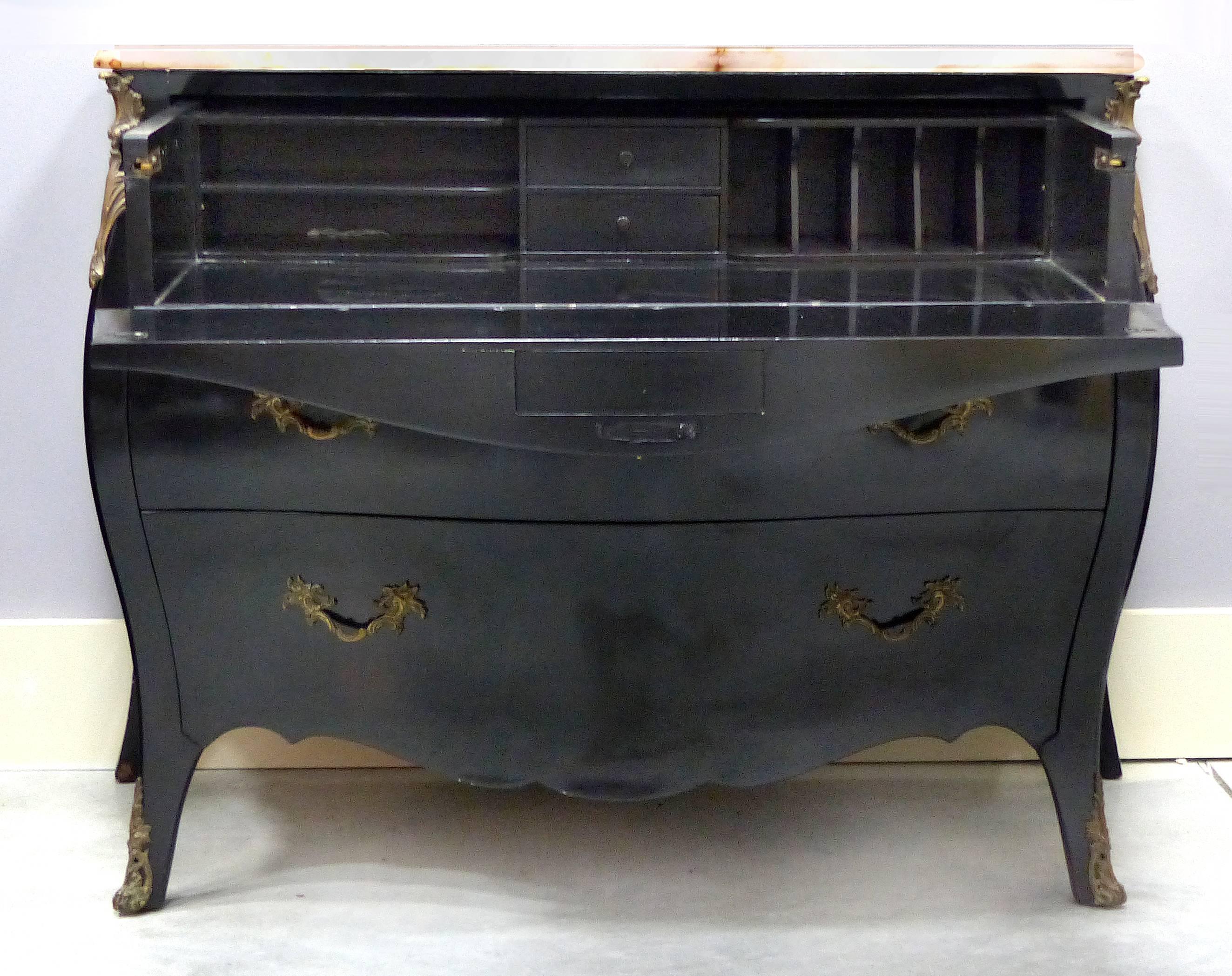 19th Century French Bombe Secretaire with Bronze Mounts and Onyx Top

Offered for sale is a late 19th century ebonized bombe secretaire with an onyx top. The top drawer drops down to create a writing surface and expose cubby holes with drawers for