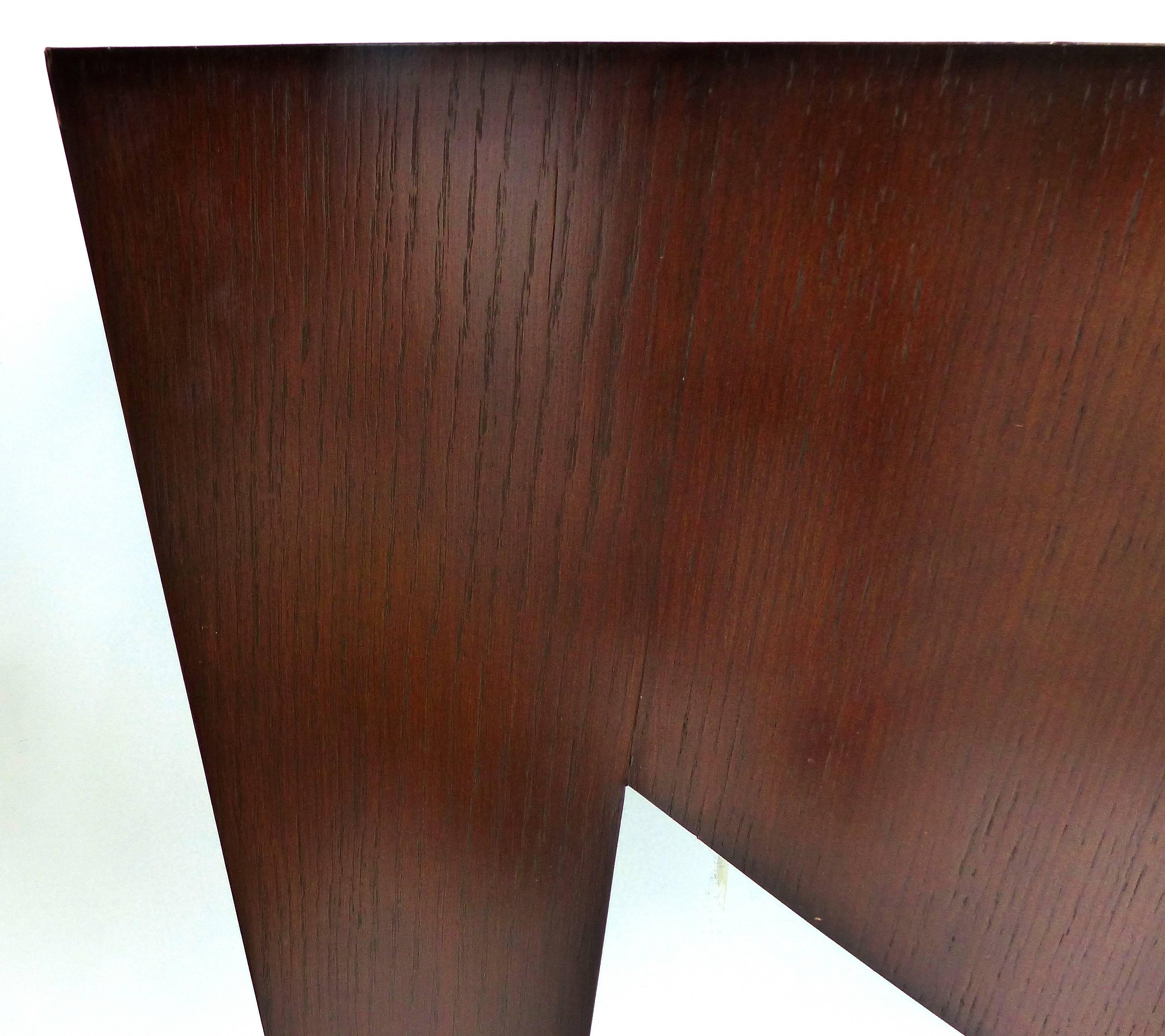 Offered is a vintage "Console de Triomphe" from Donghia's Paris Collection in black limba with gilt feet. The console is veneered in Black limba wood in a dark finish with darker edges. The console includes a French wood cleat to attach to