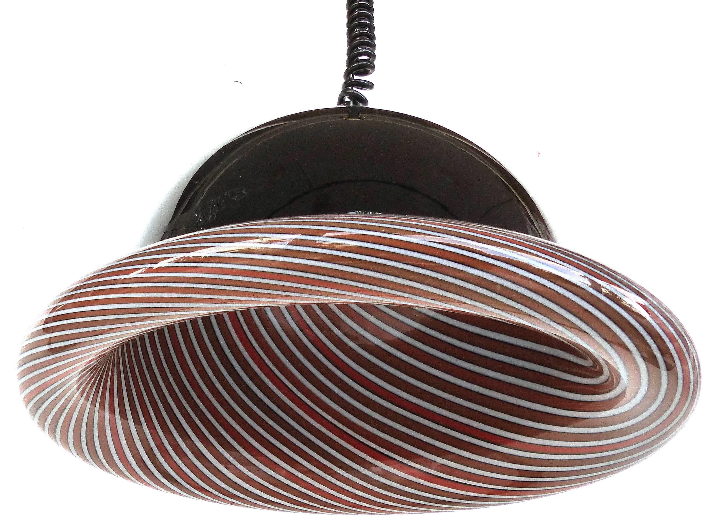1980s Effetre, Vincenzo Muretti Murano Glass Pendant Light Fixture

Offered is a Postmodern Italian Murano glass pendant chandelier. Wired and in working condition. Supported from a wire with a coiled black cord which can be adjusted in length from