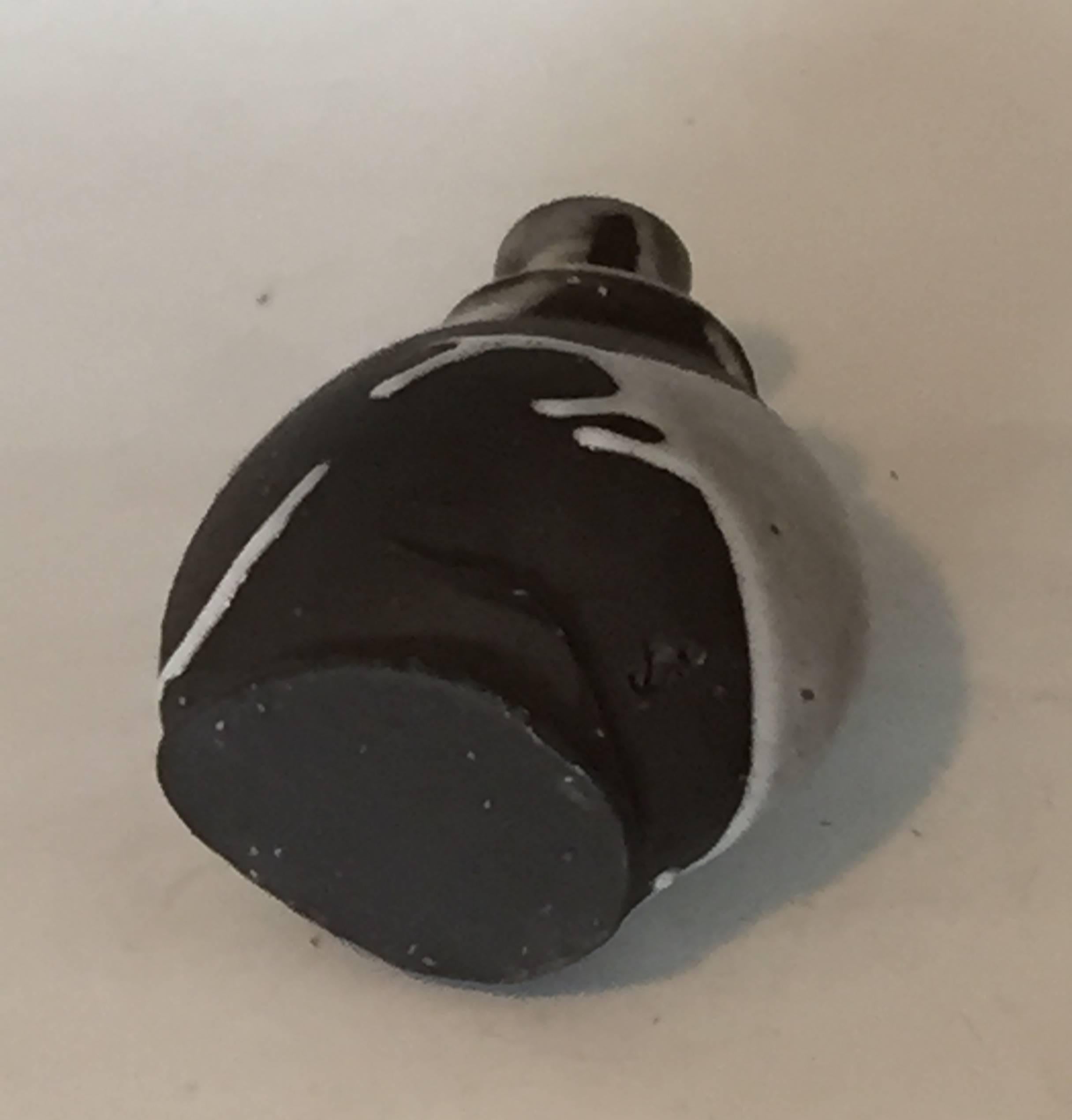 
Ryuichi Kakurezaki (b. 1950), Bizen Tokkuri, Japan, flattened and crooked flask shape with a distorted dish-shape mouth, stoneware with a splashed thick glassy creamy glaze over a chocolate colored base.
Signed box with a seal on the cover, height
