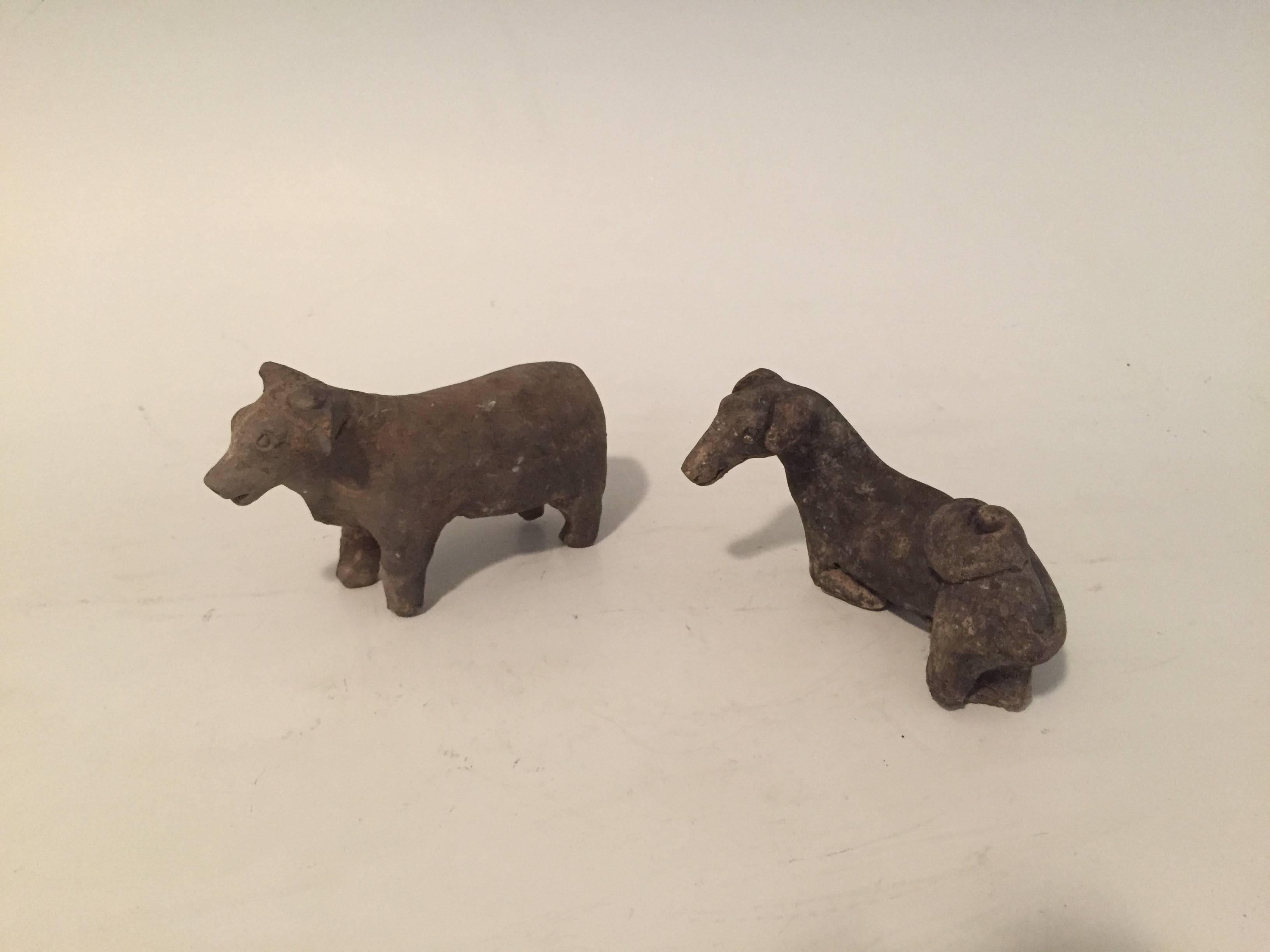 Crudely crafted pair of Han Dynasty (206 B.C. - 220 A.D.) Animals. 
2000 year old animal sculptures presumably of a cow and deer. Made of grey pottery. The cow stands on four legs, while the deer appears to be kneeling on both his front and back