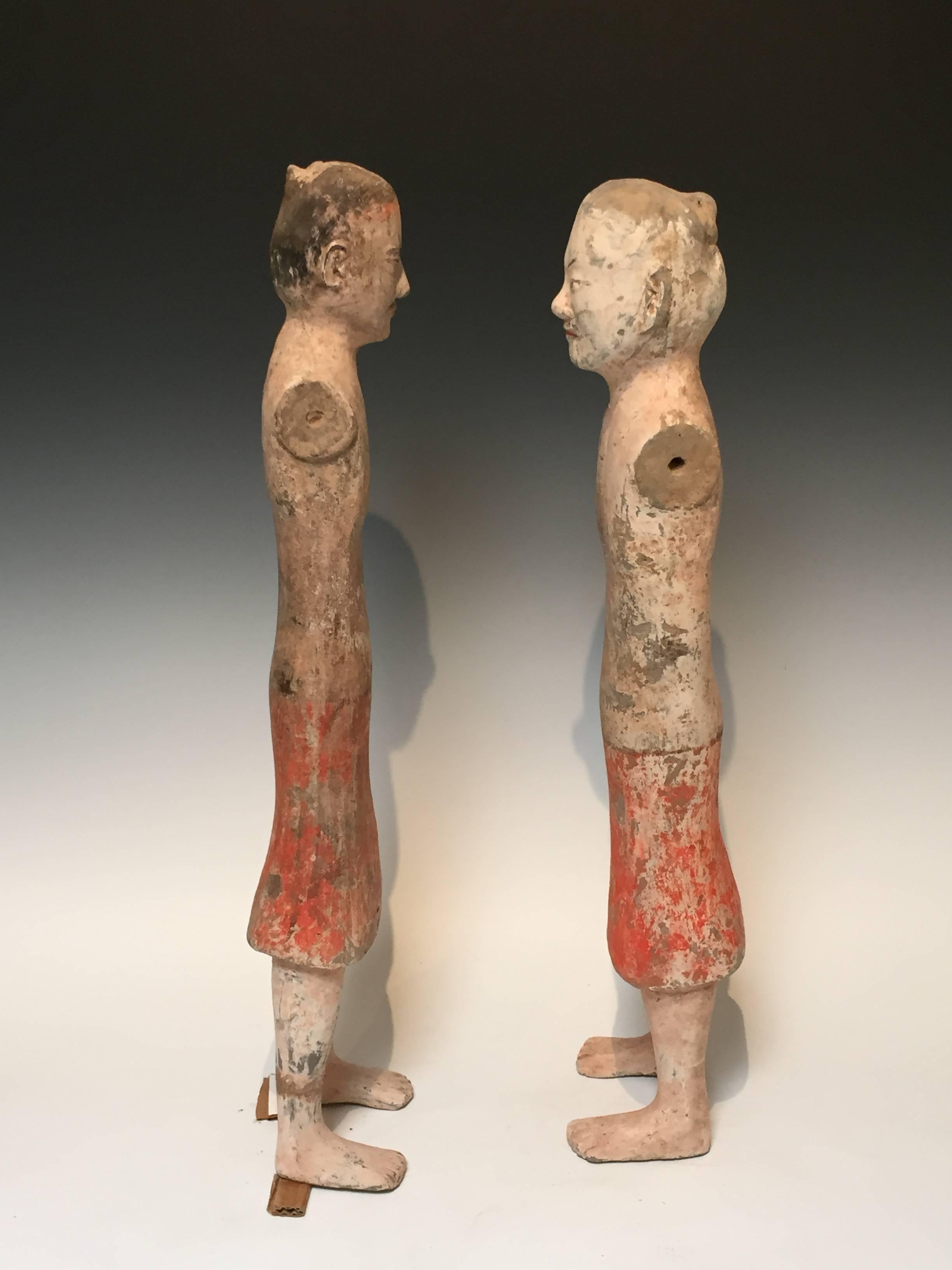 A pair of painted Han Dynasty pottery figures of male attendants.
Arms lost to age and deterioration. All original pigments.
Measures: 25" tall.