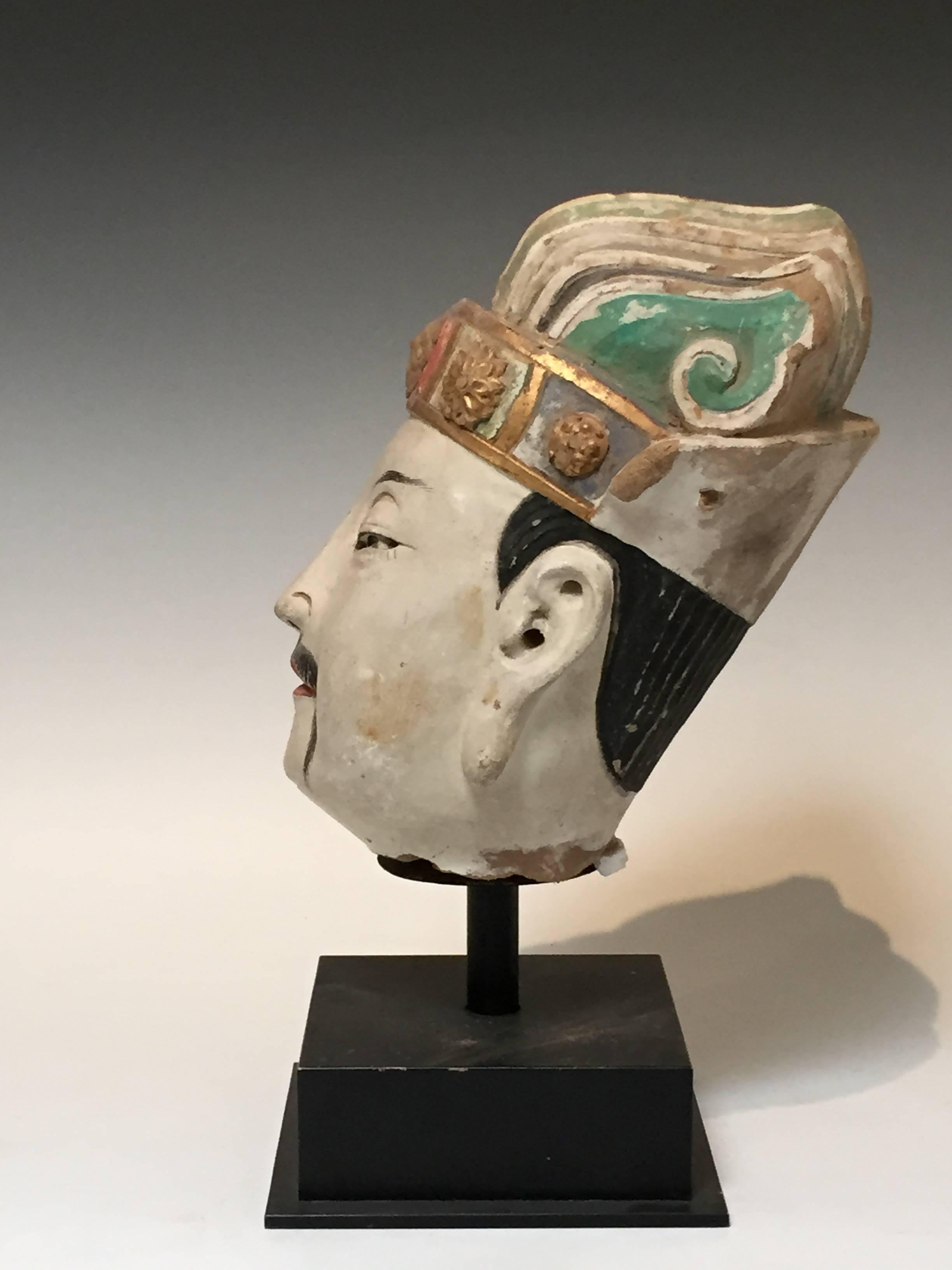 
A 15th century Ming Dynasty Stucco head of an official. 
All original pigments. Made of stucco and wood.
Measures: 16