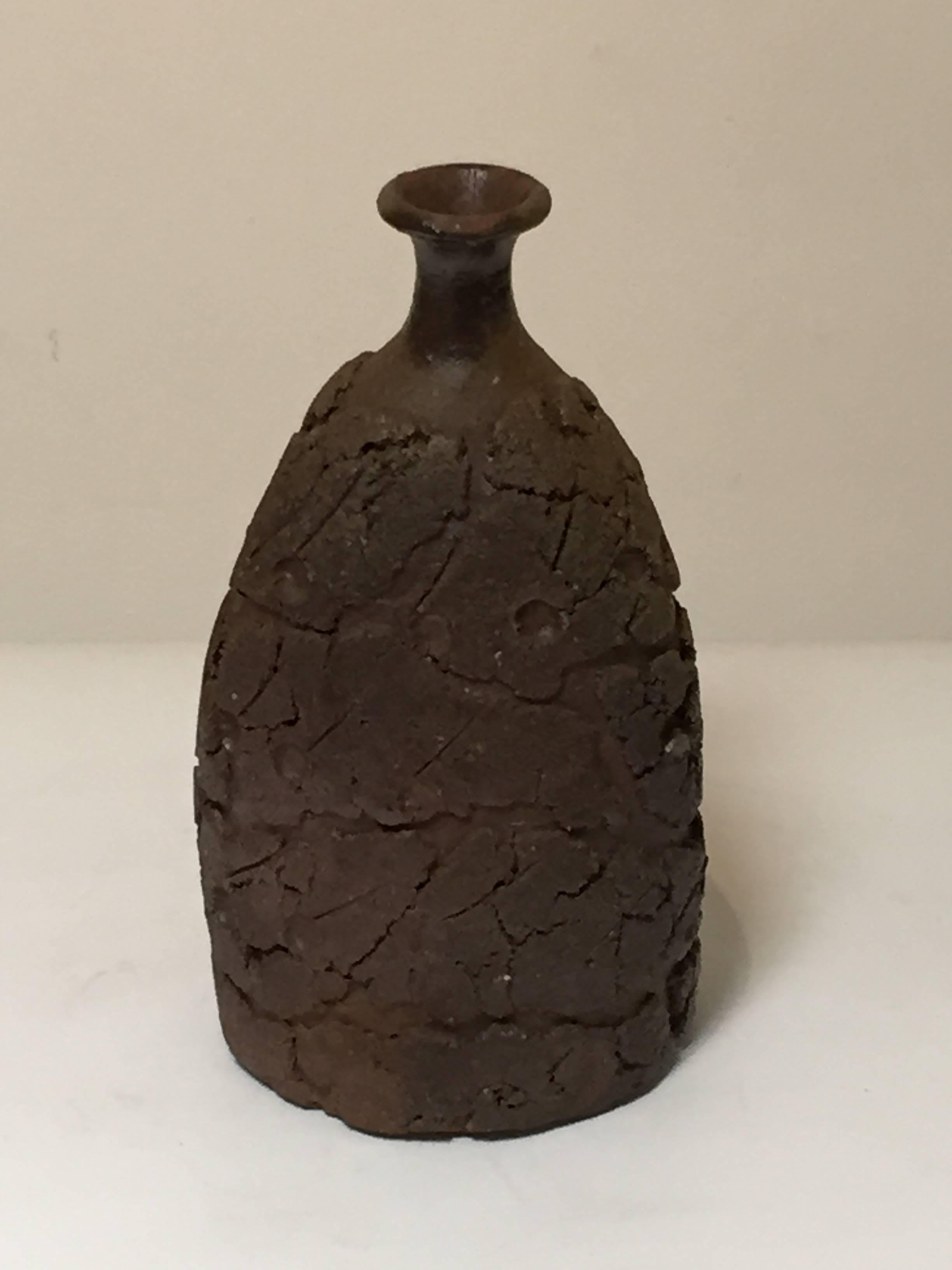 Offered by J R Richards
A textured bottle shaped vase by internationally known ceramic artist Harada Shuroku (b. 1941- ).
A course and rough clay body, fired in the ancient tradition using an anagama kiln.
Includes custom made and signed box.
