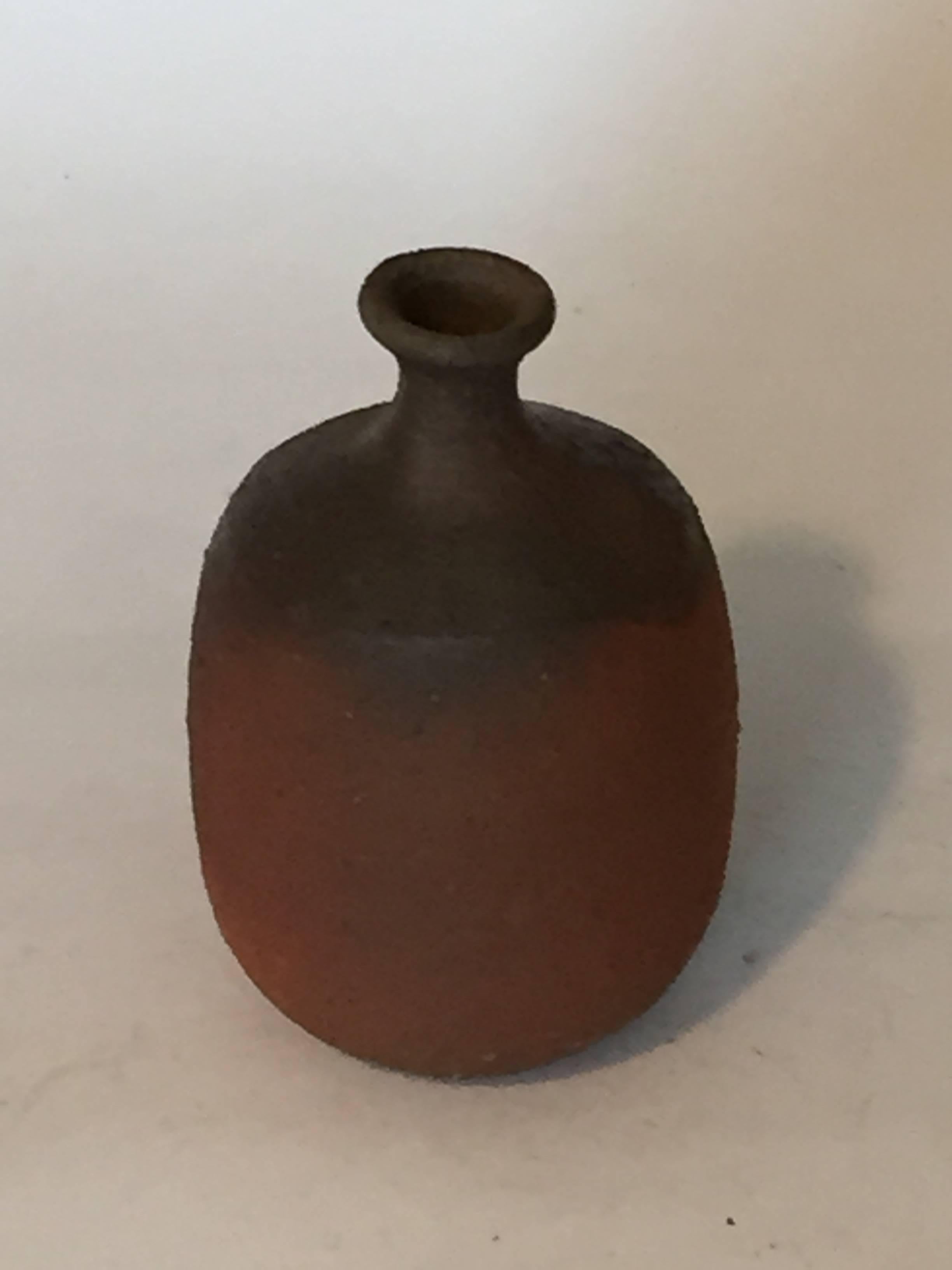 A wonderful 20th century sake bottle by Toshu Yamamoto (1906-1994).

Toshu Yamamoto was born in Inbe, Bizen City, and became a National Living Treasure in 1987. Trained under artists such as Yaichi Kasube, he was a master of the pottery wheel.