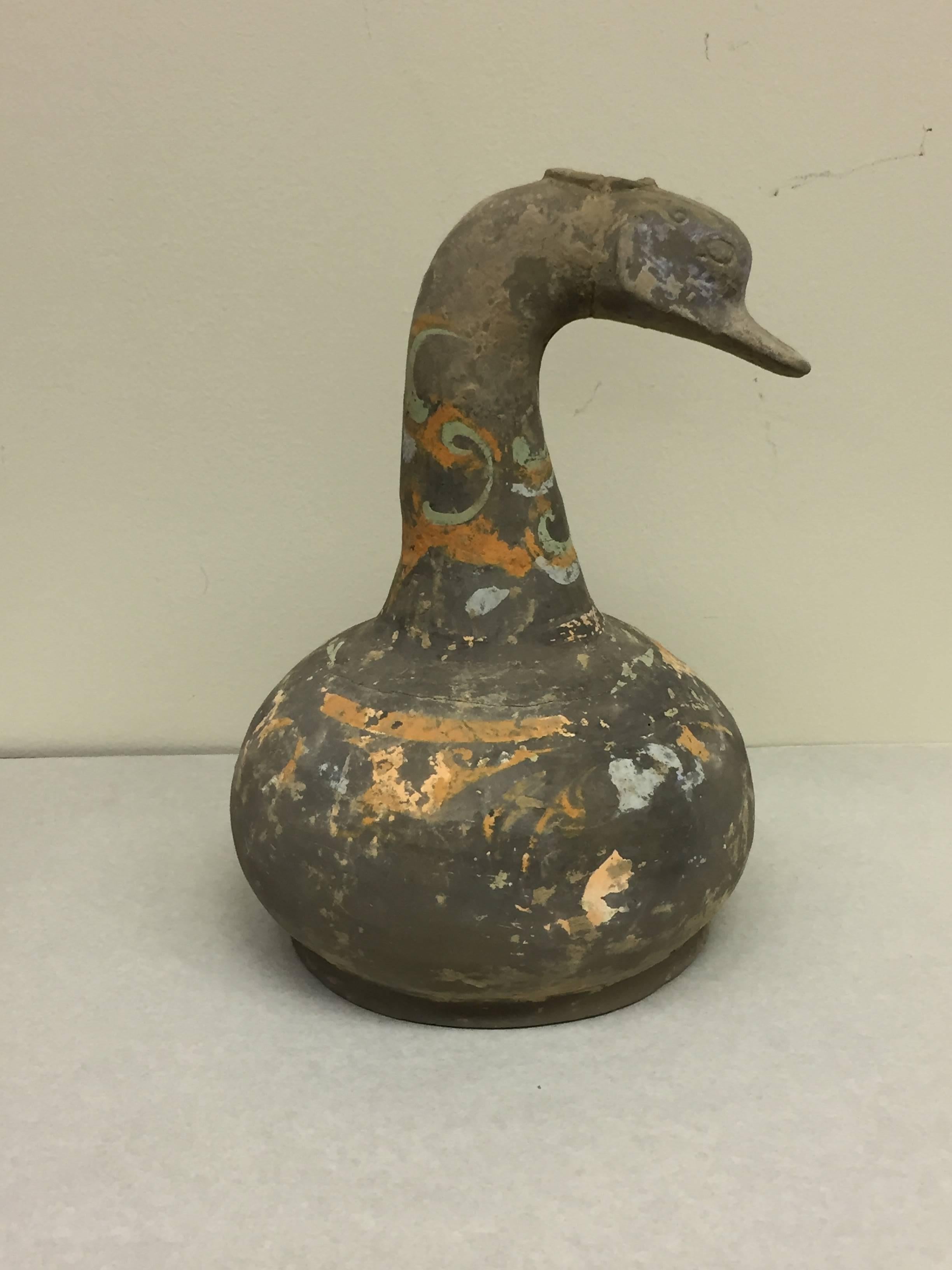 Offered by J R Richards
An ancient pottery vessel with duck shaped head and beak.
From the Han dynasty (206 BC-220 AD), with pigments.
Measures: 12.5" tall x 9.5" wide.