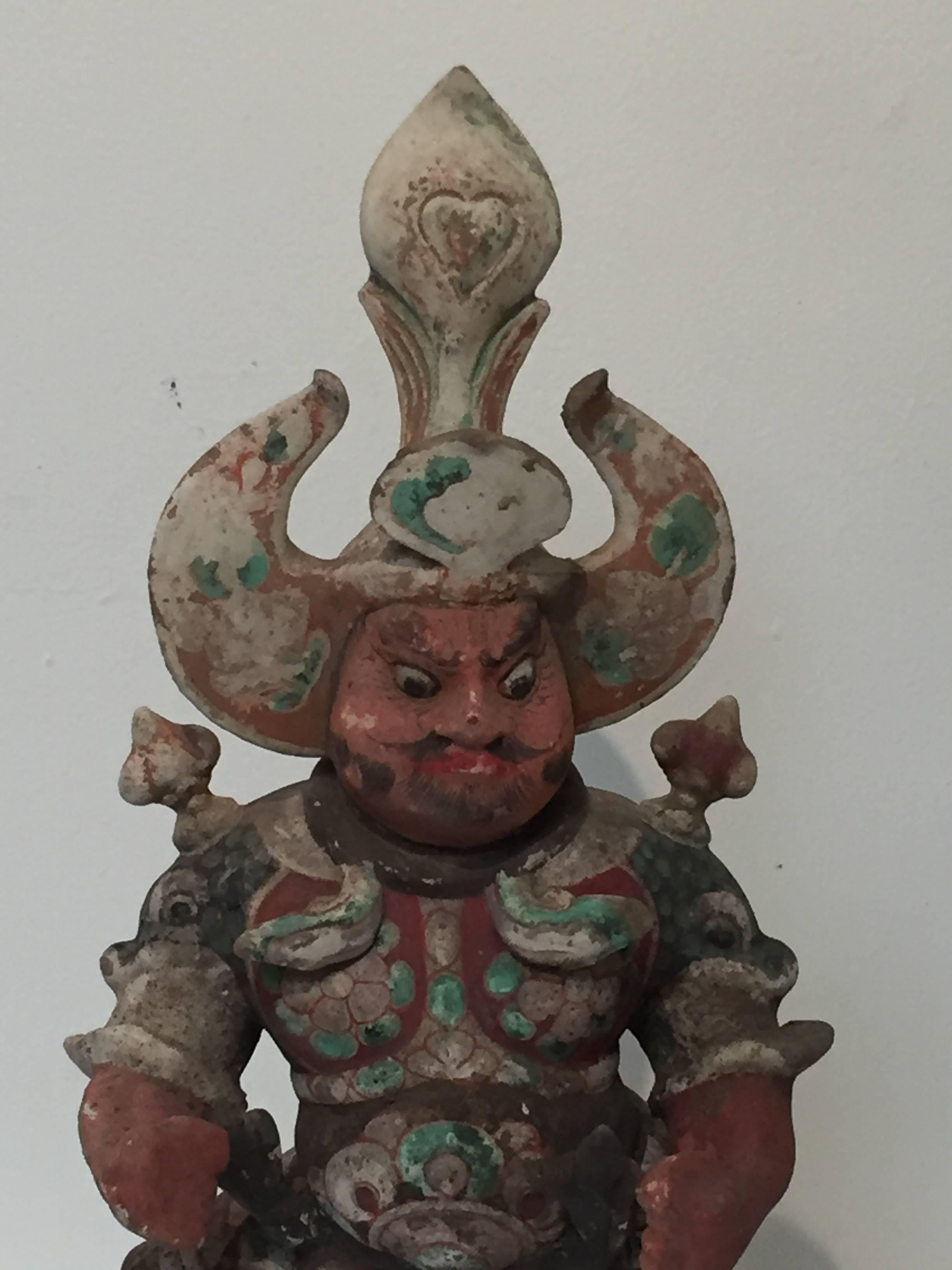 Tang dynasty (618-907 A.D.) guardian figure, also known as a Lokapala.

This magnificent Buddhist Lokapala or guardian king originally served as tomb guardian in an aristocratic Tang burial. Wearing an elaborate headdress and armor, and with a