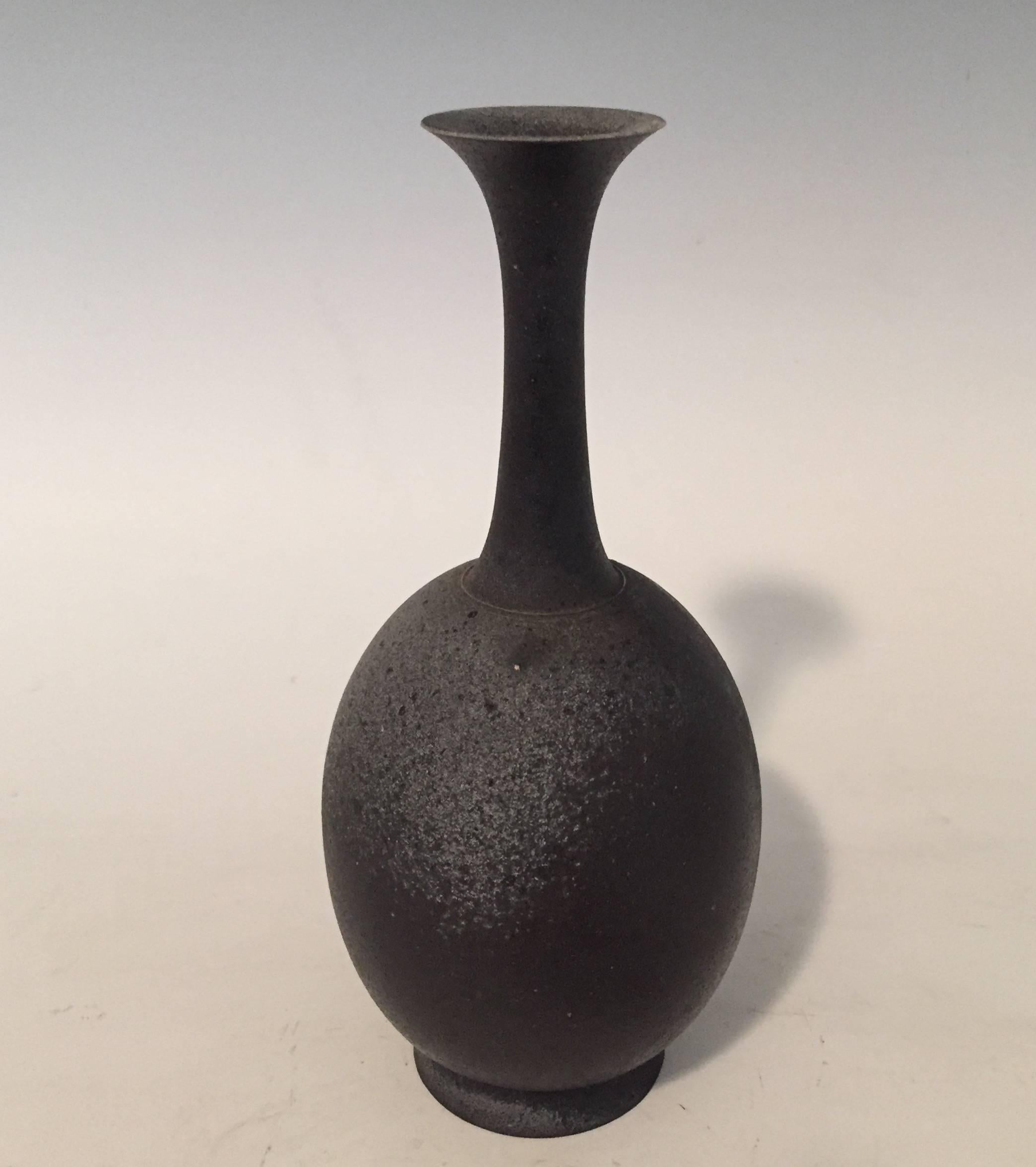 A one of a kind stoneware vase by Japanese Ceramicist Koji Toda (born 1974-).
Of rounded form with elongated neck, and simple lines in the shape of a lotus flower.
Inspired by bronze forms from pre 12th century water pitchers.
The beautiful