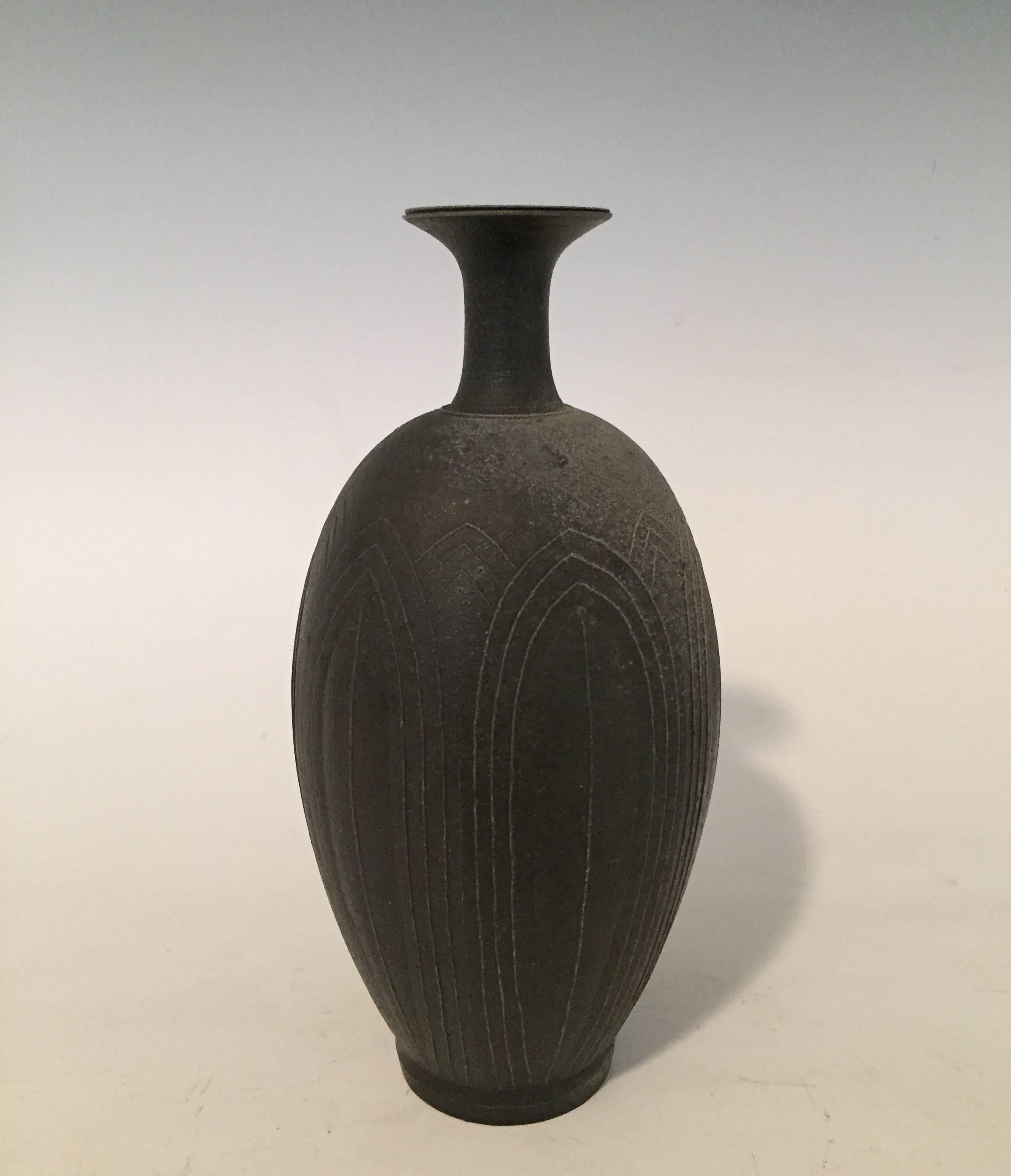 
A one of a kind stoneware vase by Japanese Ceramicist Koji Toda (born 1974-).
Of rounded form with elongated neck, and simple lines in the shape of a lotus flower.
Inspired by bronze forms from pre 12th century water pitchers.
The beautiful