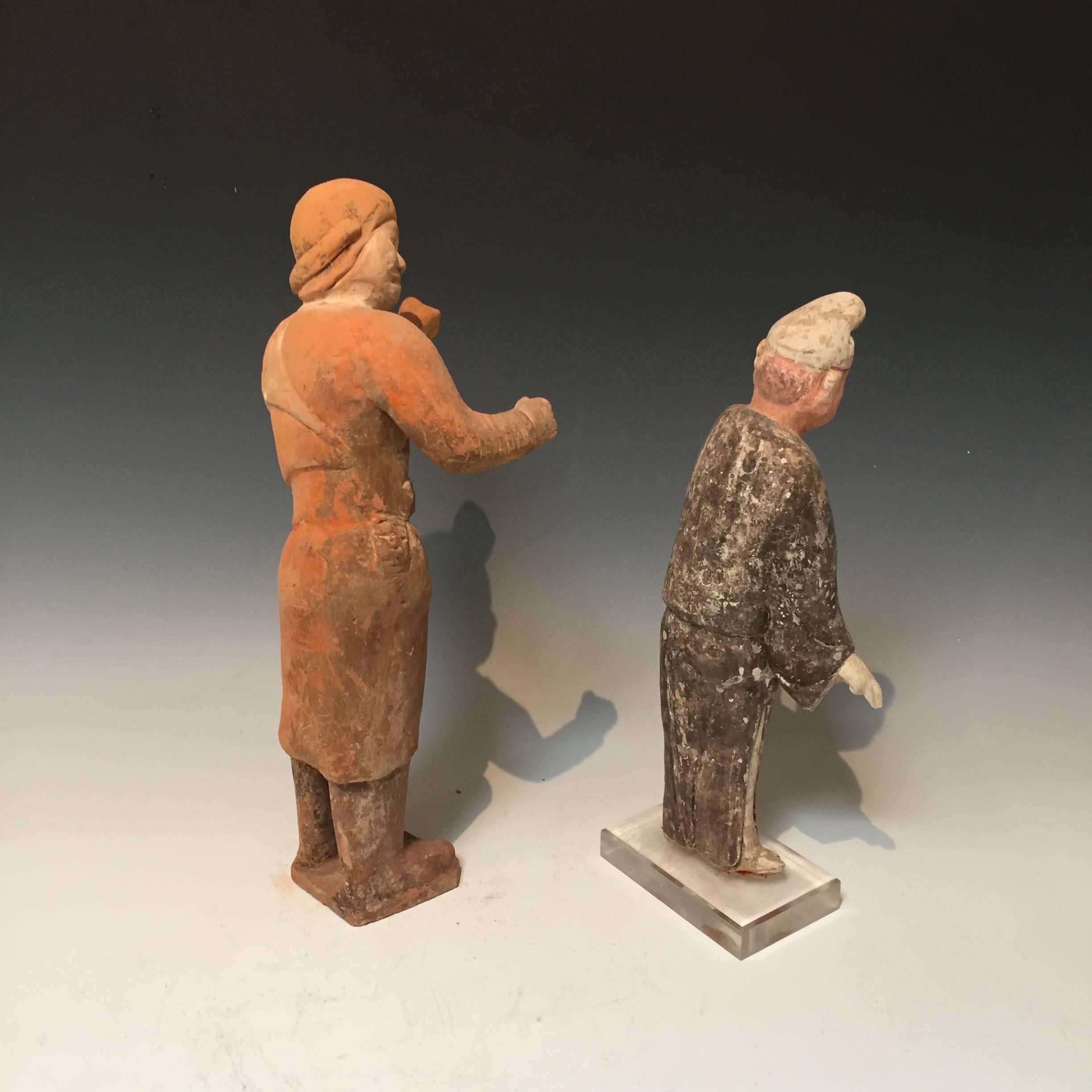 A pair of pottery figures from the Tang dynasty (618-907 A.D.)
One is likely a groom, and the other is a male attendant.
Some original pigments remain.
Groom is 16