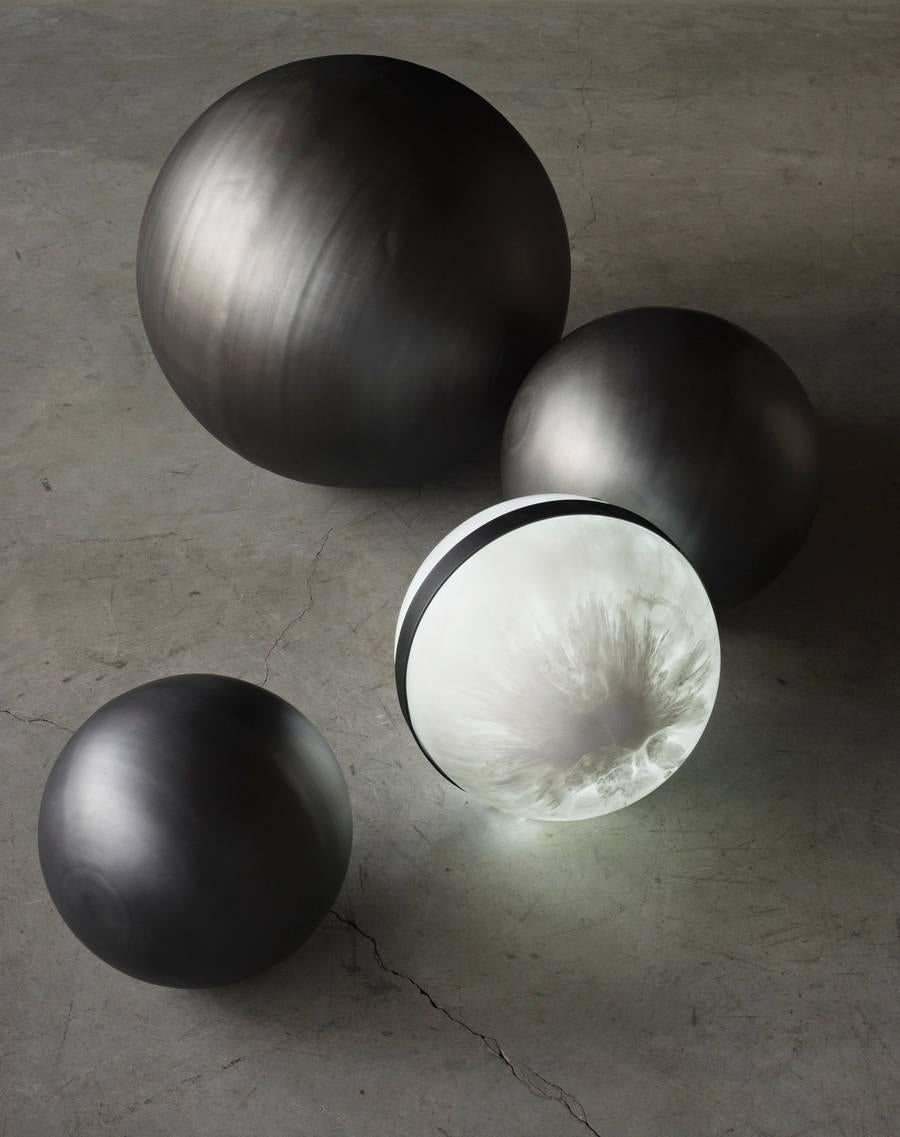 Illuminated resin spheres with steel banding. 
2700K cool white or 3200K warm white LED available. 
Sold with steel ring cradle and electrical cord in clear or black.

Measures: 15