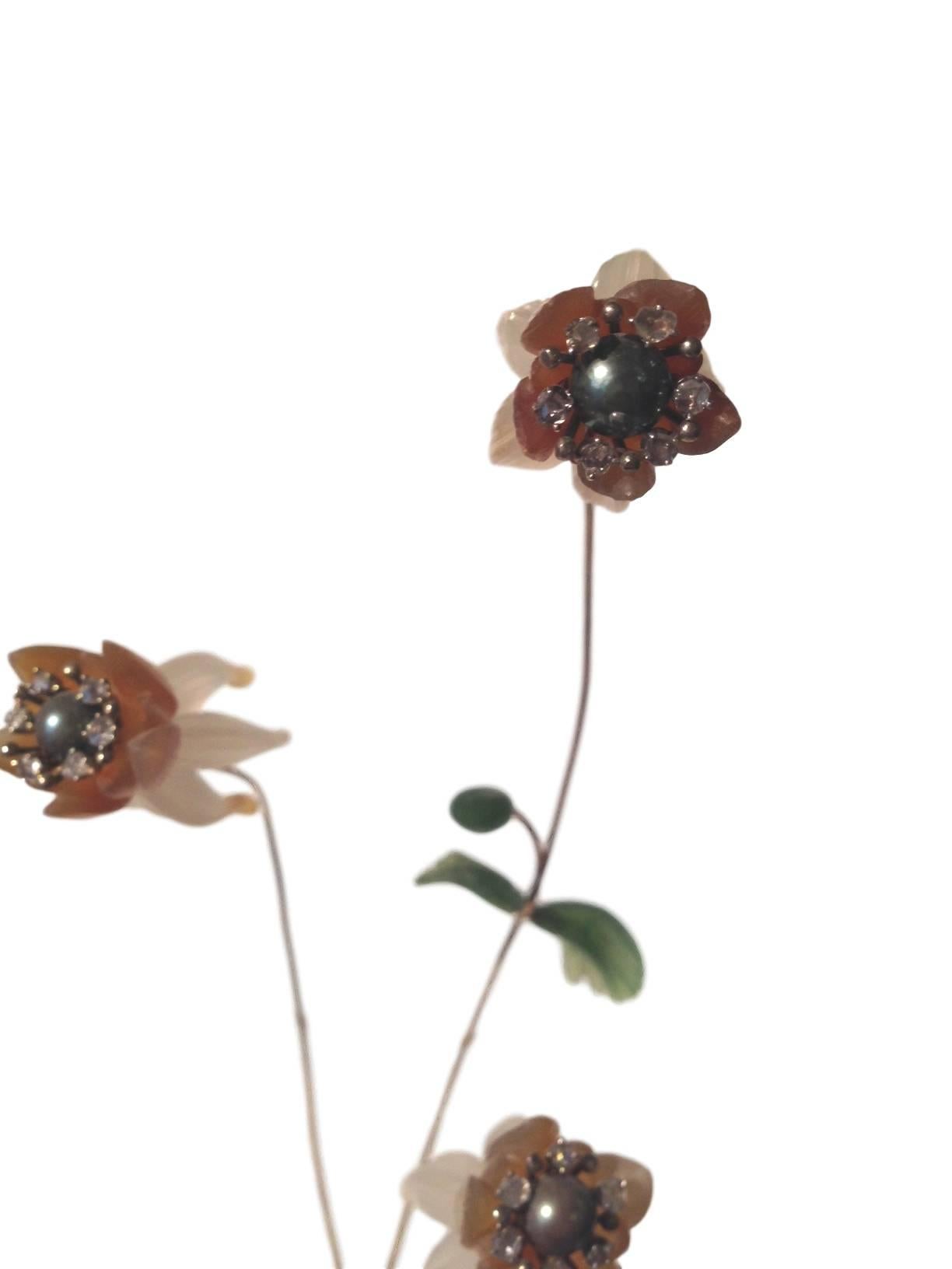 A very special and delicate Russian hardstone and jeweled flower study from the 20th century. The rock crystal base issuing three delicate flowers fashioned from quartz and cut diamonds is attached to a gilt bronze stem with nephrite leaves. This