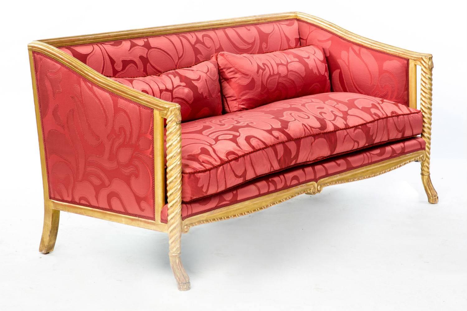 This is a stunning carved frame Medici sofa upholstered in Abbondio fabric by Bergamo, finished with premium trim and 23-karat gold finish on the alder wood frame.