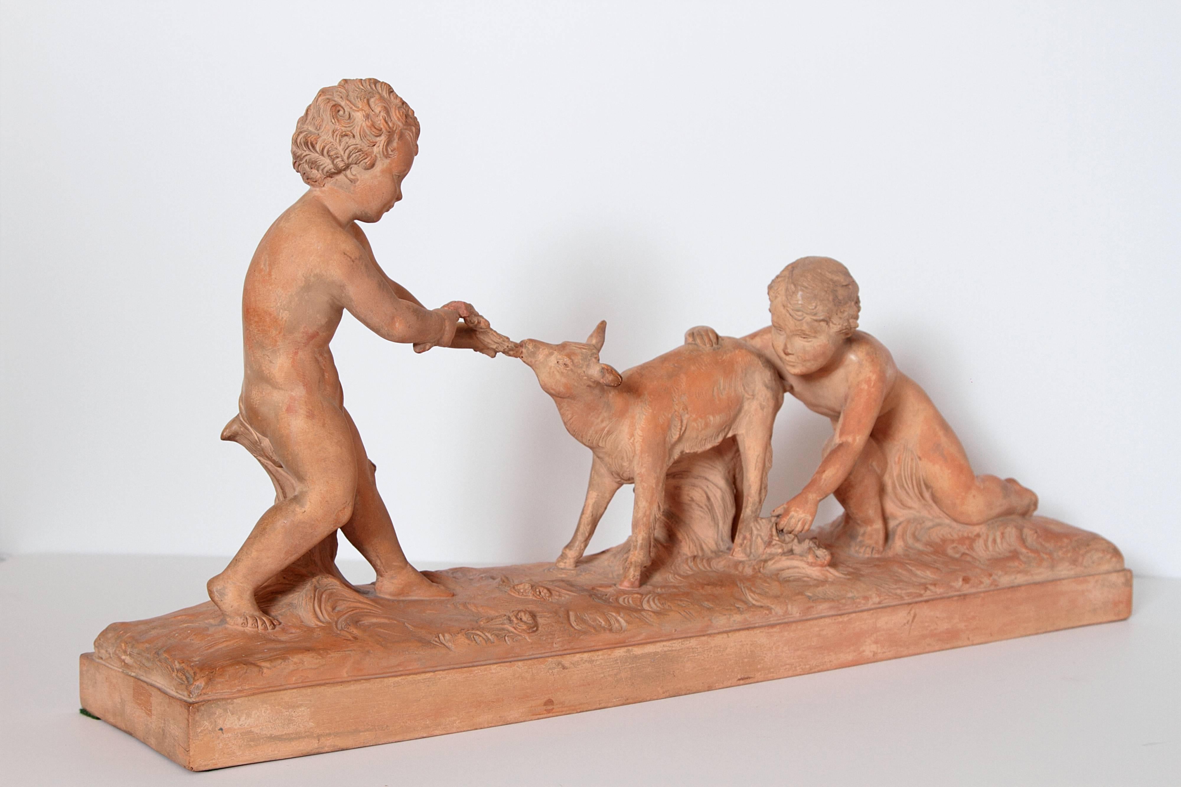 A large Art Deco terracotta sculpture by Ugo Cipriani, circa 1930, of children and a deer. Ugo Cipriani, also known as Menneville et Rochard, left Fascist Italy and moved to Paris, France where he created many Art Deco sculptures in terre cuite,