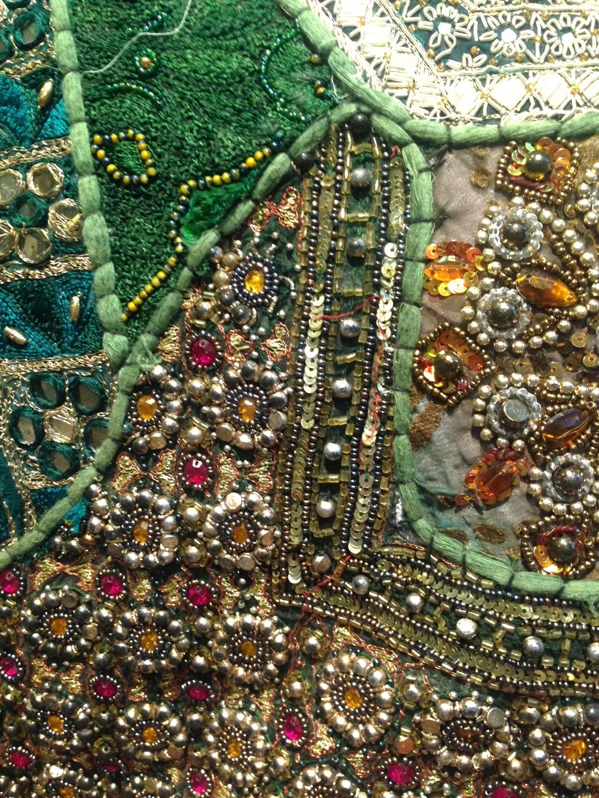 This hand-beaded tapestry, made in India is equally as intricate as it is stunning. The entire tapestry is covered with precious and semi precious beads, sequins and stones.