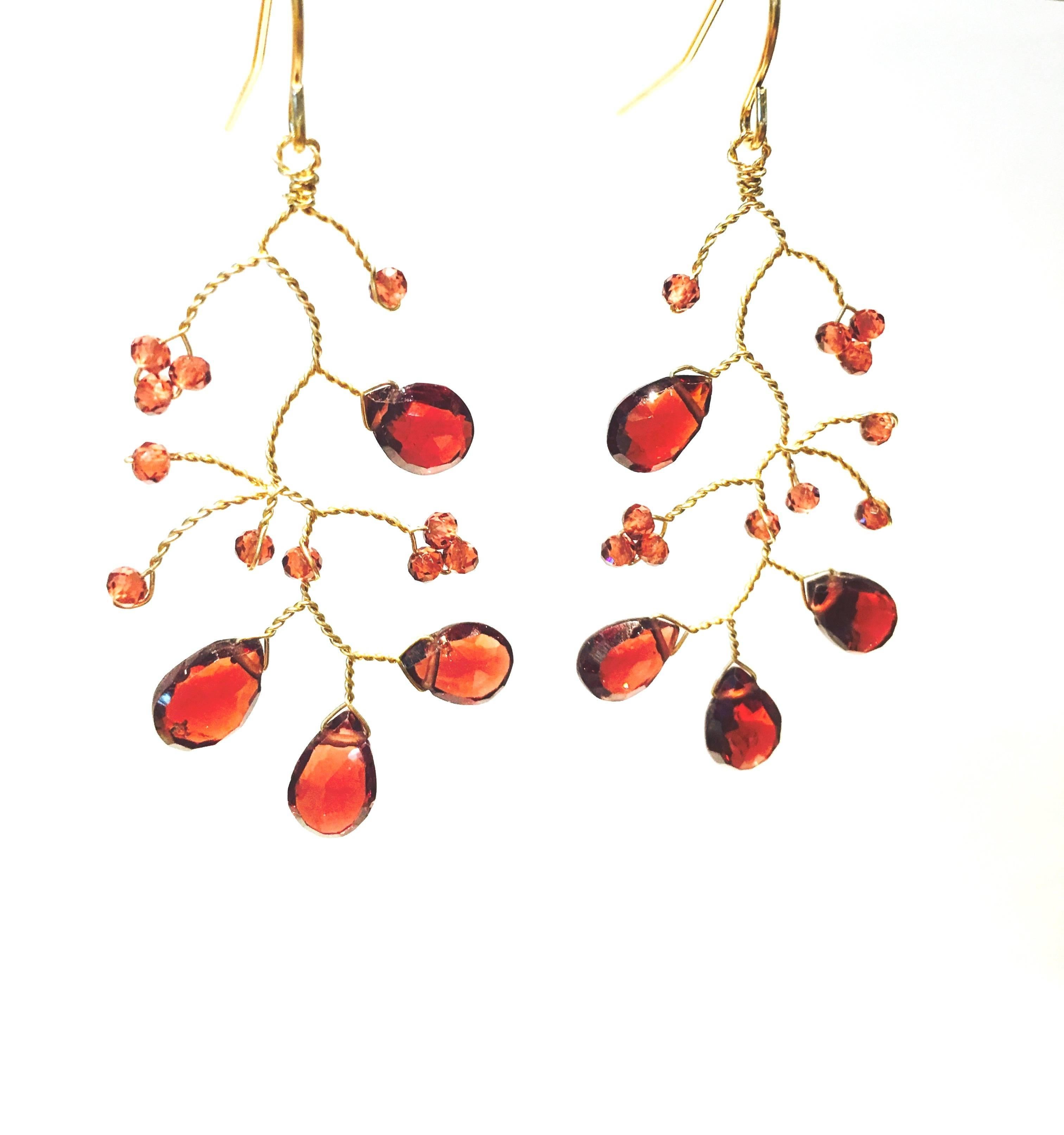 These very fine and delicate garnet branch chandelier earrings are handmade in the United States by a one of a kind artisan. The branches are made of 14-karat gold and decorated with stunning garnet stones.