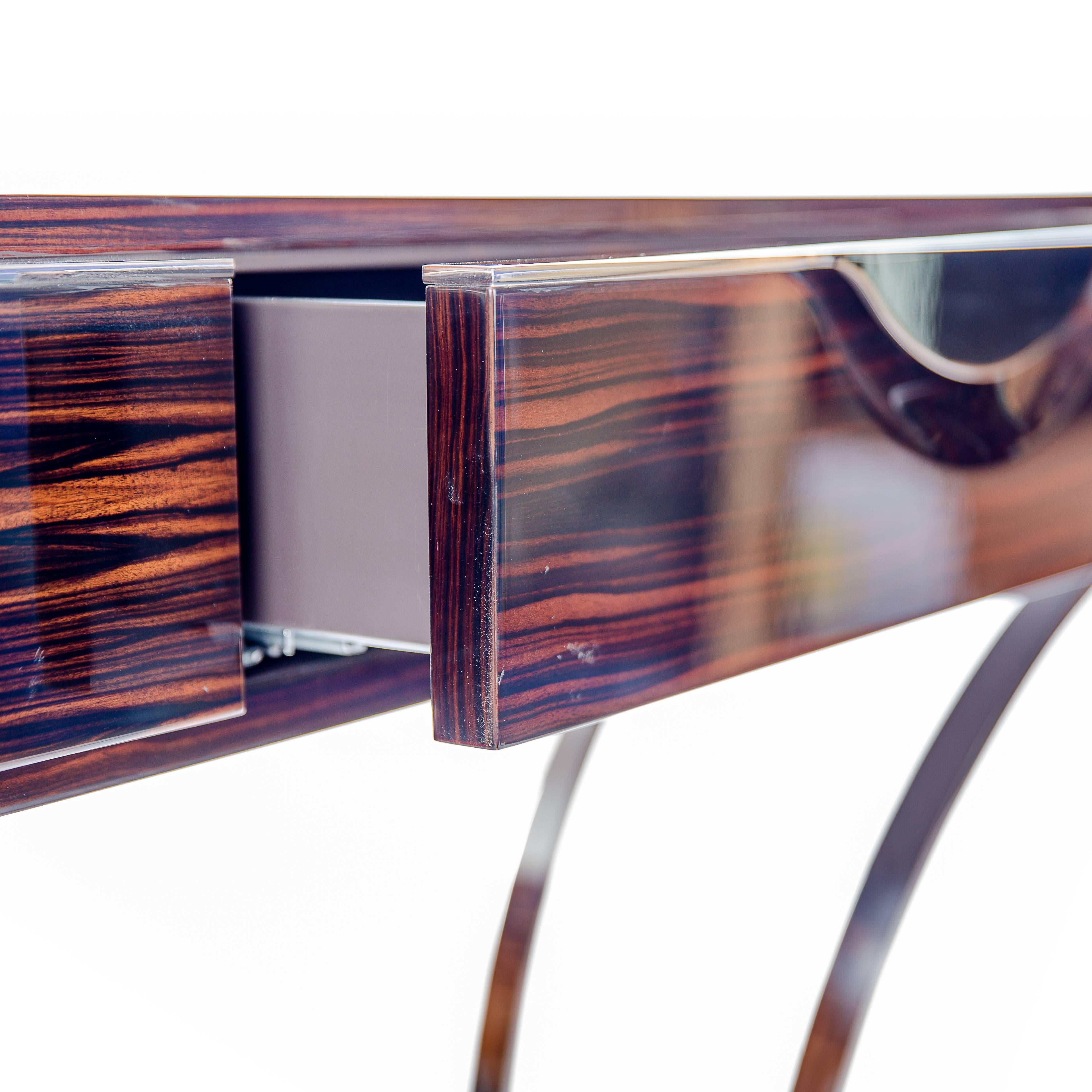 This is a stunning 'Royal' console table in a glossy ebony with chrome swooping legs. The entire front pulls out to be a drawer and slides back in with ease. Truly beautiful piece of furniture!
