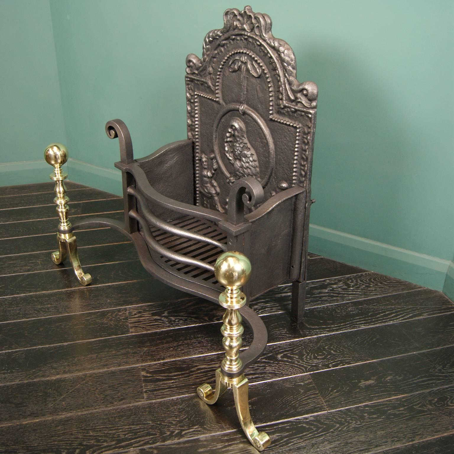 Wrought iron fire basket with scroll finials, shaped round fire bars, polished brass dog legs with ball finials and an ornate fire back depicting a parrot.