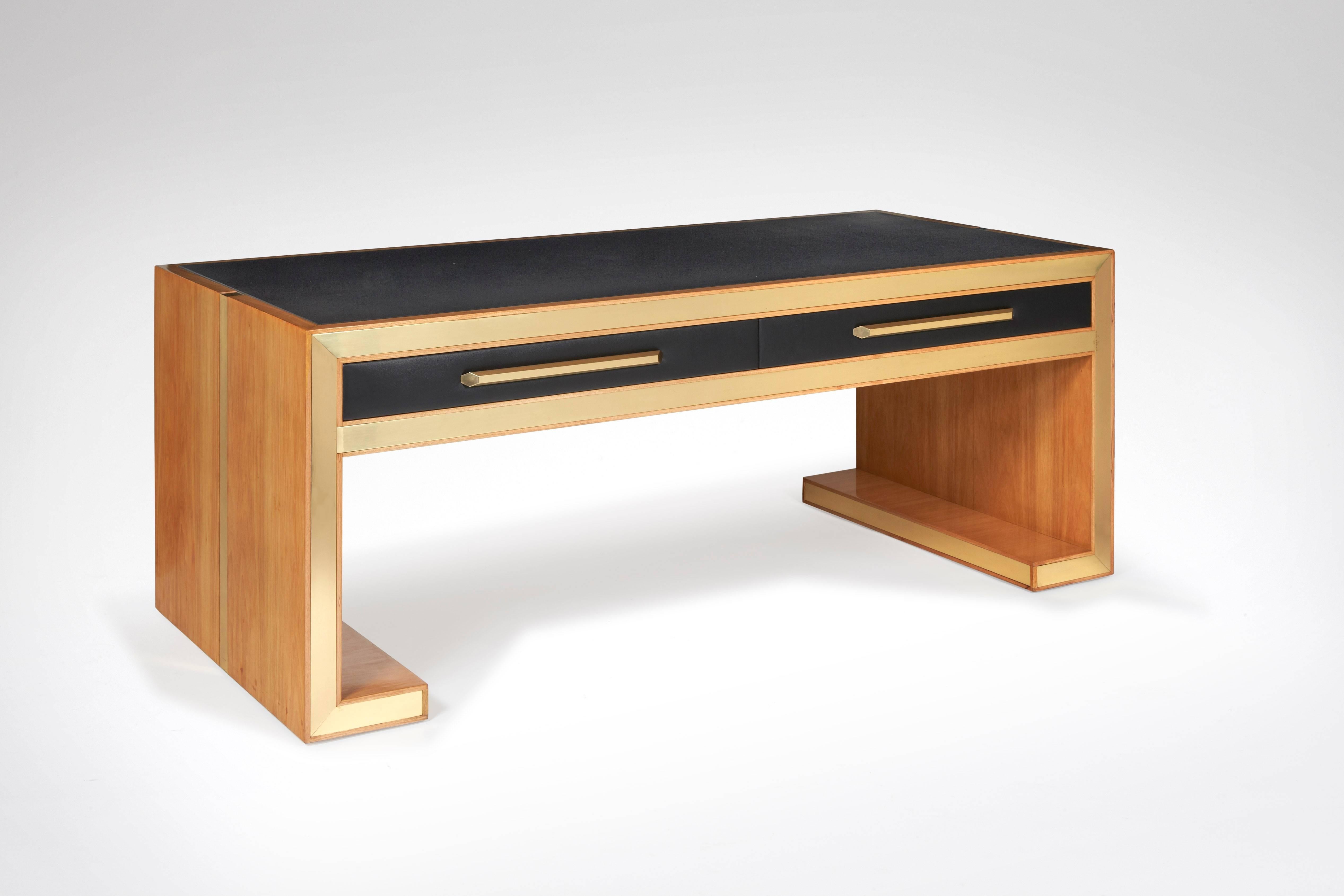 A Sycamore and gilded brass presentation table or desk, black leather.