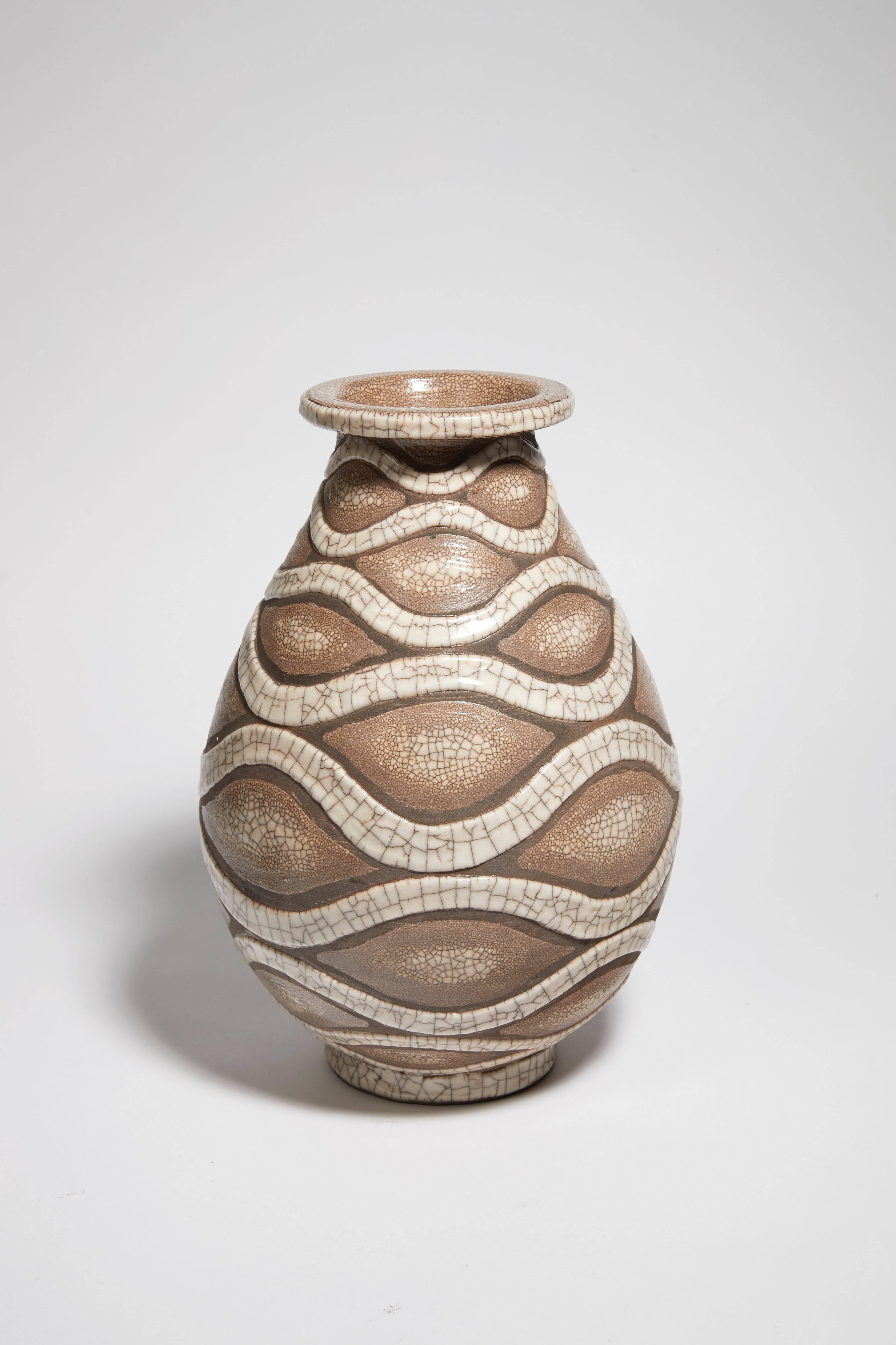 Ovoid-shaped earthenware vase, decorated with enamelled cracked white interlacing’s on a grey snakeskin base. Signature 'RB' under the base.