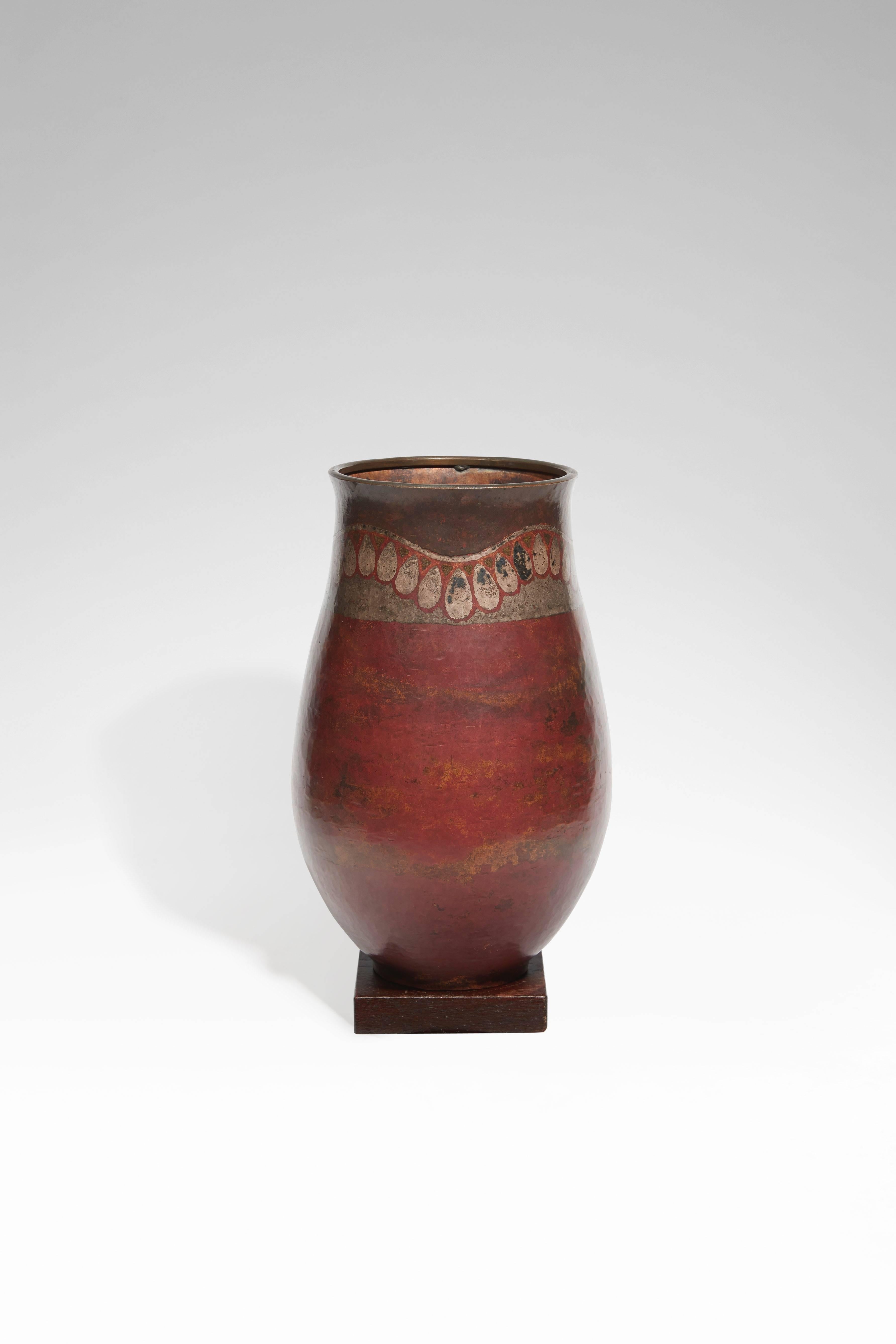 A Dinanderie ovoid-shaped copper vase called "Ondulation de pendeloques", with slightly splayed neck and squared base, the decor made up with fire patina and silver inlays on a base with fire patina, red on the neck and shaded grey on the