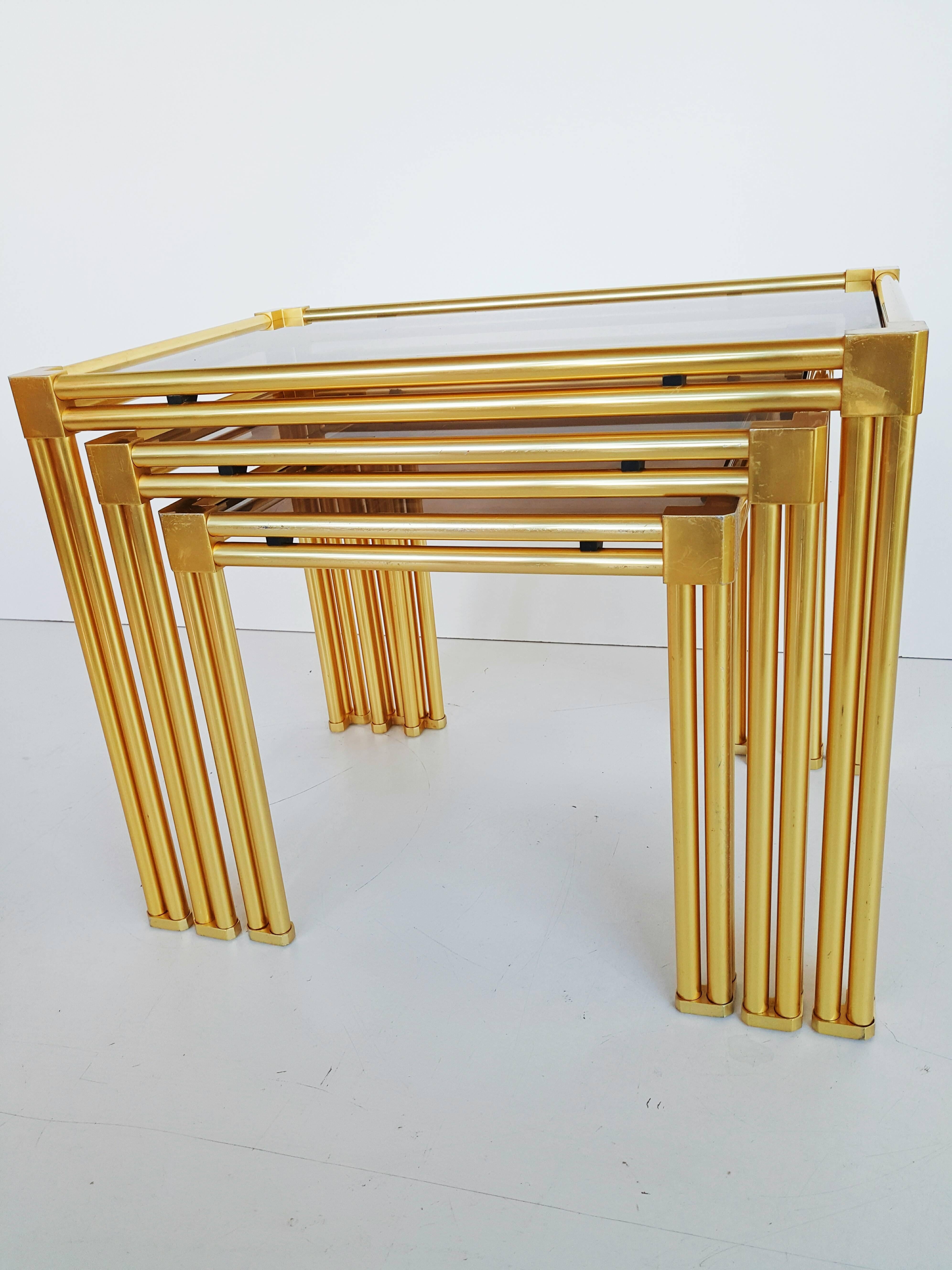 Beautiful French brass and smoked glass nesting tables, circa 1970, in perfect vintage condition.
Dimensions(cms): 54 W x 36 D x 43 H; 45 W x 36 D x 39 H; 36 W x 36 D x 34 H.