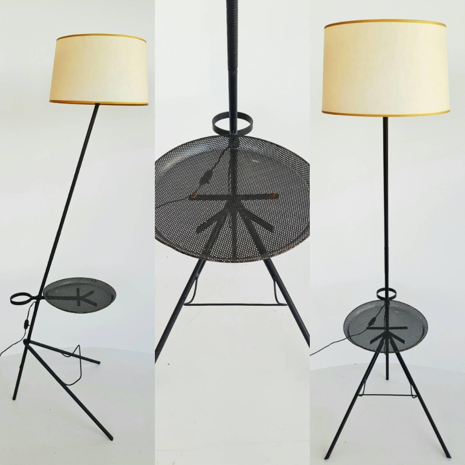Rare and beautiful Mathieu Matégot floor lamp, manufactured by Ateliers Matégot (France), circa 1950. Lacquered metal structure with original paint, with built in magazine rack and drink holder. The ring up top would be for either a flower pot or an