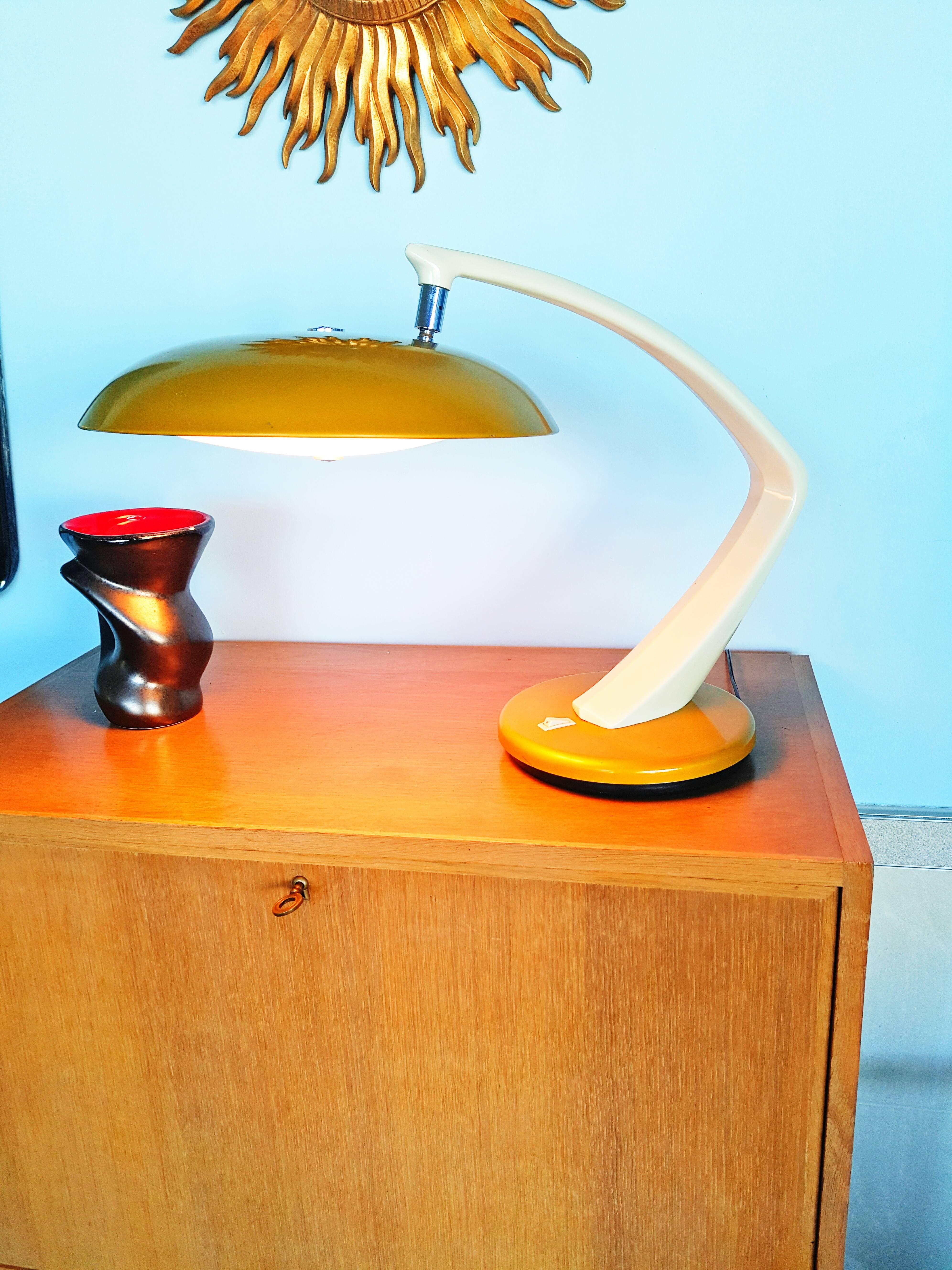 A beautiful ocher and creame boomerang table lamp, executed in the 1960s by Fase, Madrid. Have a swivel base and an adjustable lampshade with two sockets. In very good condition.