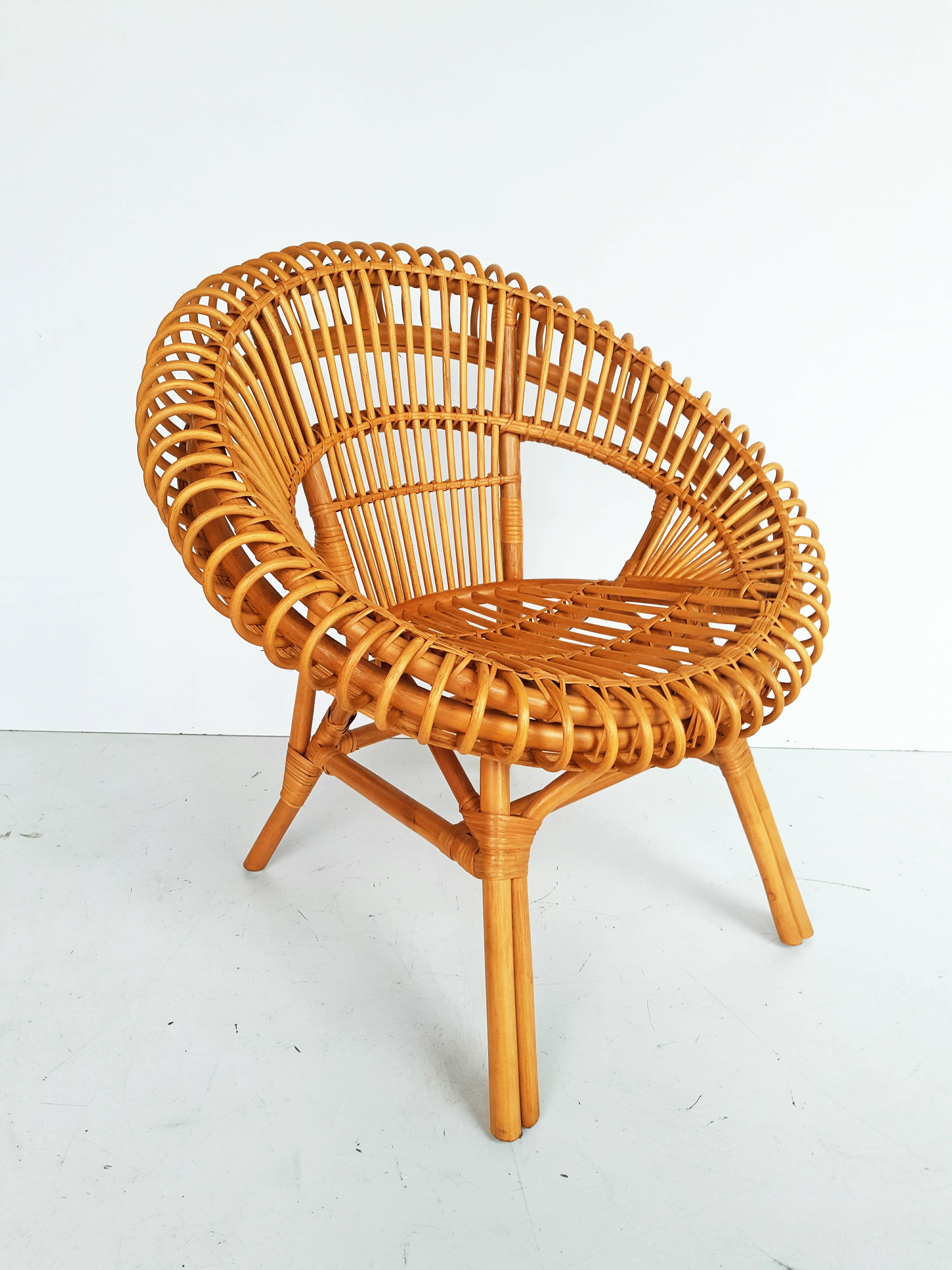 Beautiful midcentury rattan armchair in perfect vintage condition. In the style of Franco Albini for Boccina.