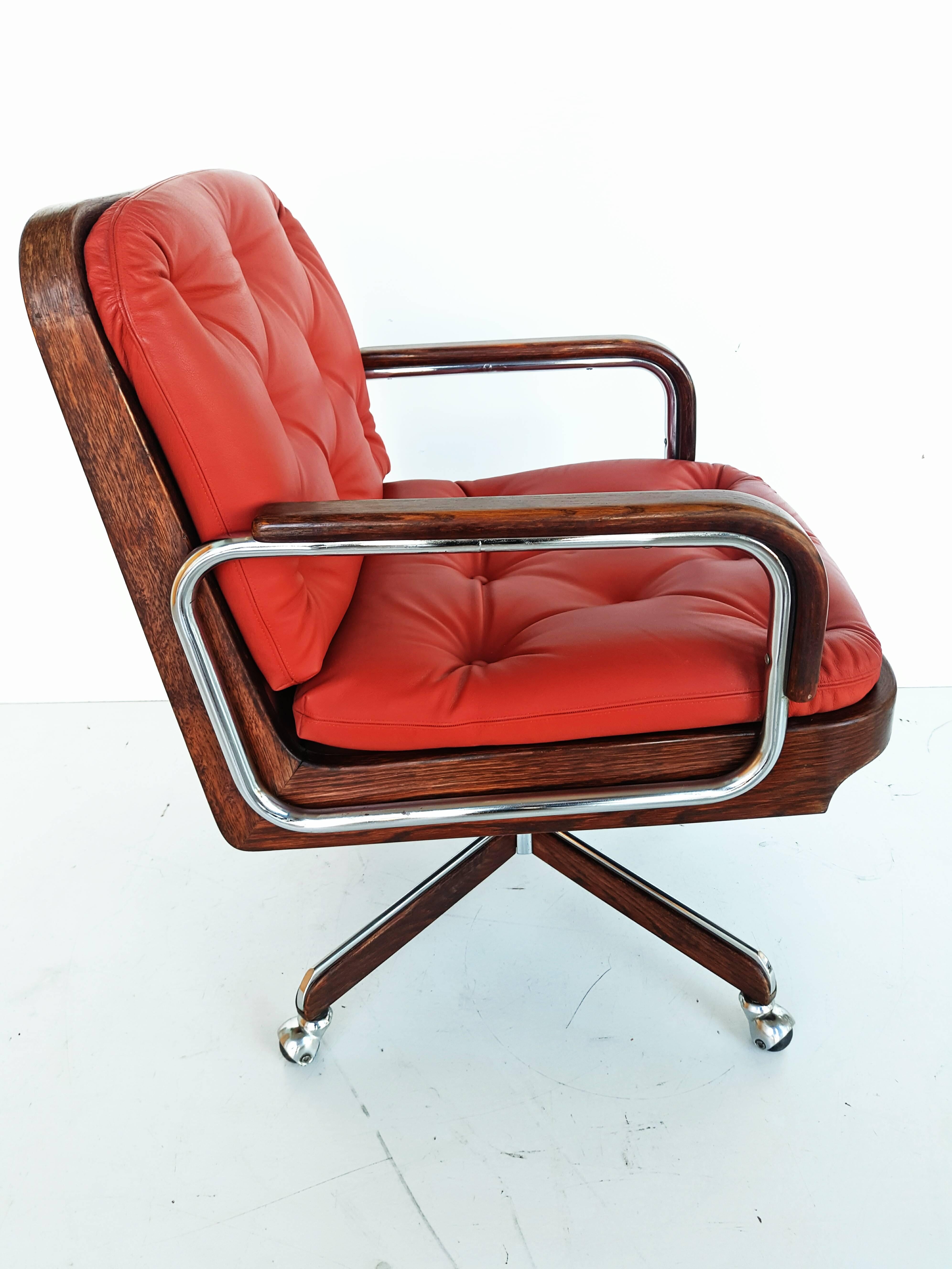 Rare swivel armchair, in a beautiful blood orange leather with chrome and wood manufactured in Spain by Ag Barcelona in 1970s. Very high quality and very heavy, adjustable height with a minimum seating of 45 cm and a maximum of 60 cm. Very