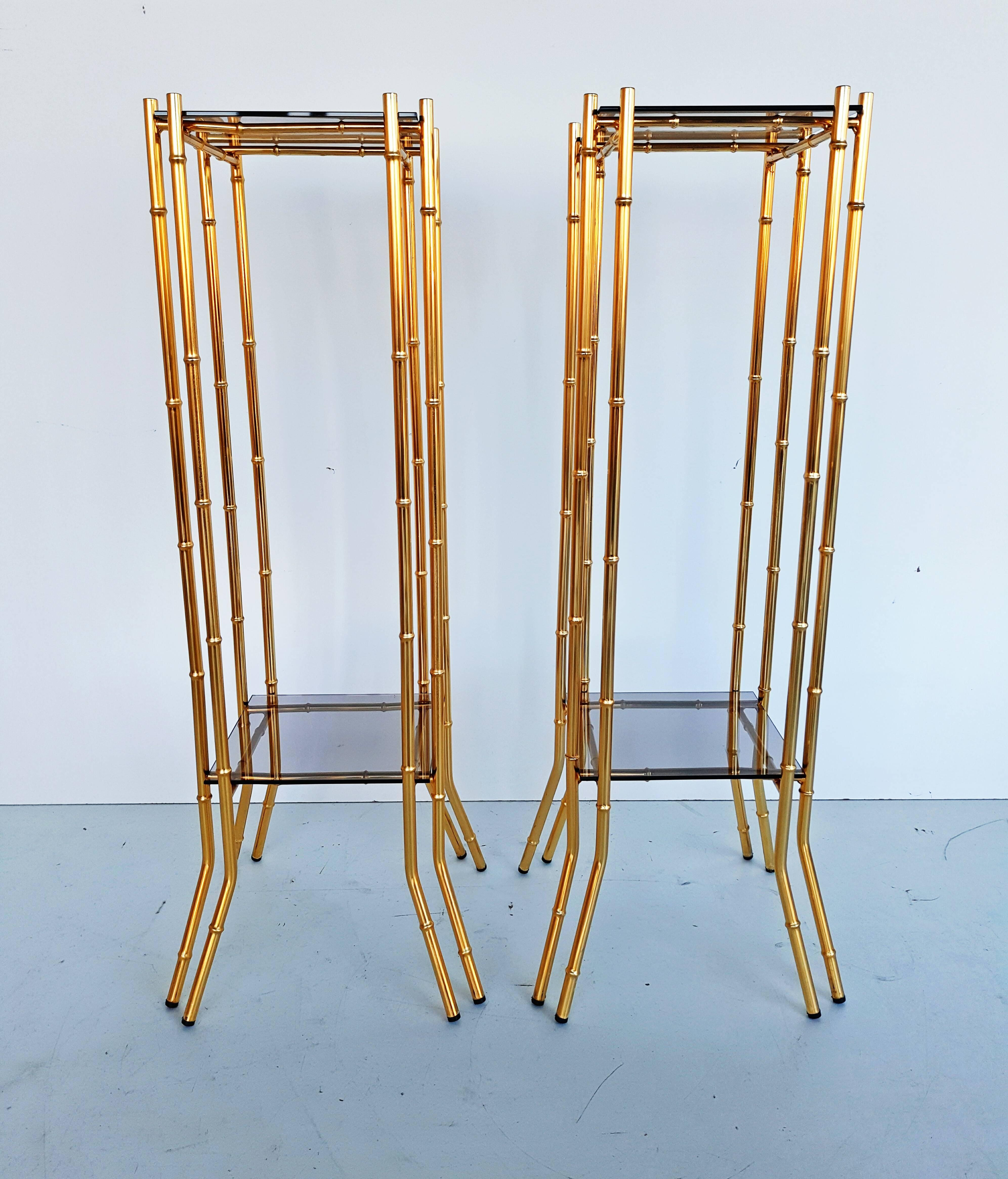 Beautiful pair of faux bamboo brass end tables in the style of Maison Bagues, manufactured in France in 1960s. Smoked glass top, distance between the two 68 cm.