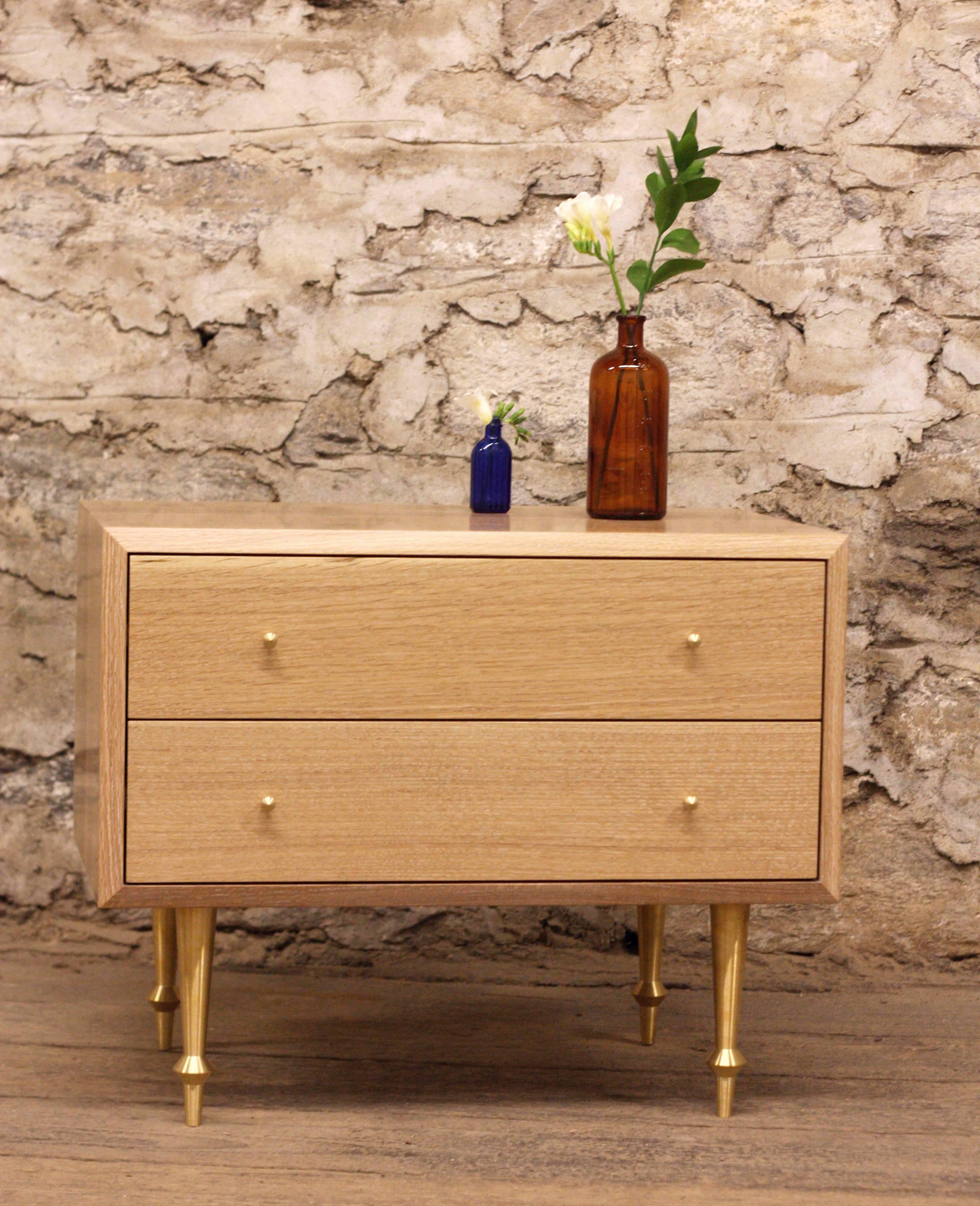 As shown:
Solid white oak with cerused finish.
Custom brass legs and turned brass drawer pulls.
Fabric lined drawers upon request at an additional fee.
Oil and wax finish.
Dimensions: 21” H x 26” W x 18” D.
Custom sizing available.
Offered in