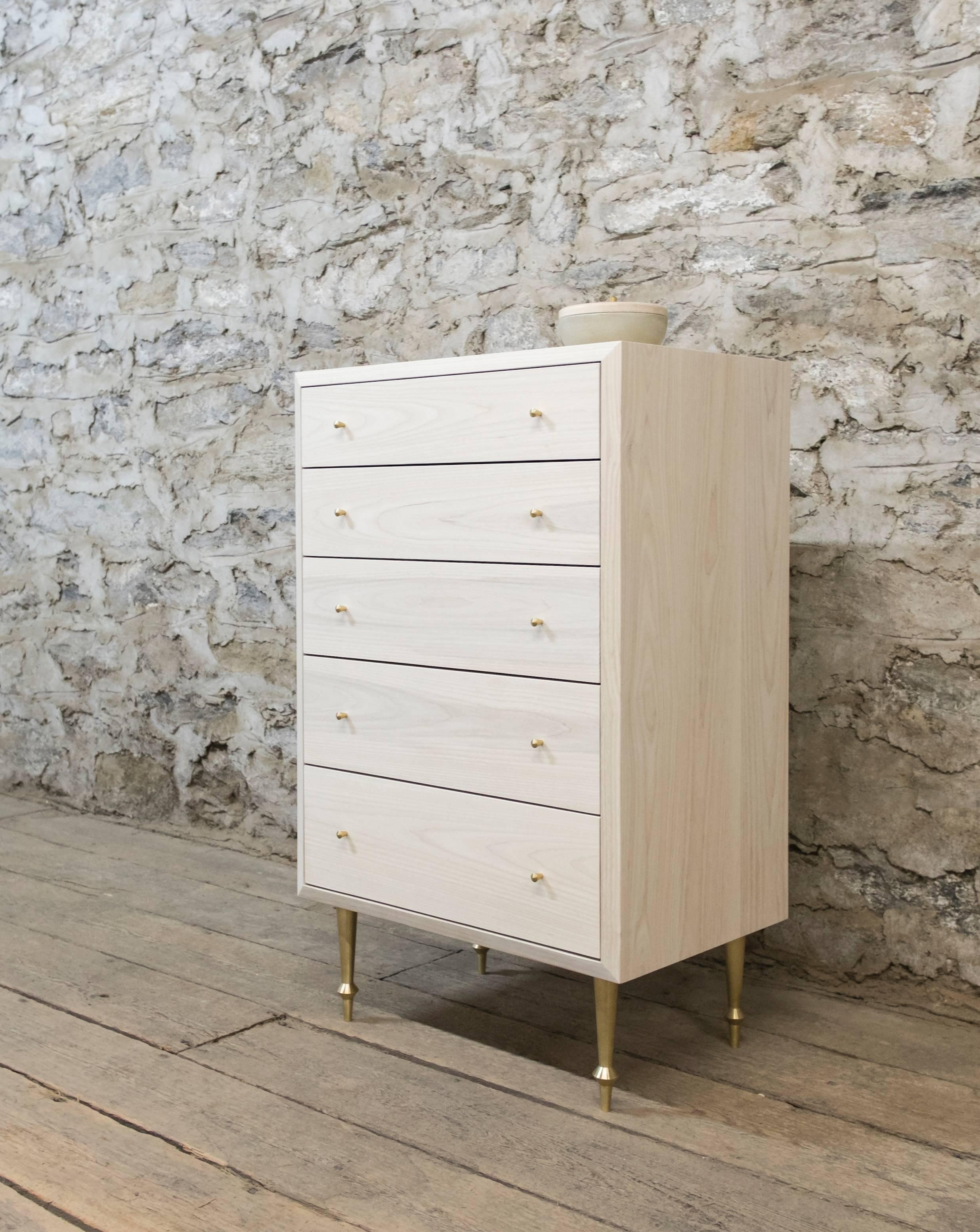 Solid bleached ash with turned brass legs and drawer pulls.
Fabric drawer linings upon request for an additional fee.
Flat waterborne finish.
Dimensions: 42” H x 26” W x 18” D.
Custom sizing and configurations available.
Offered in a variety of