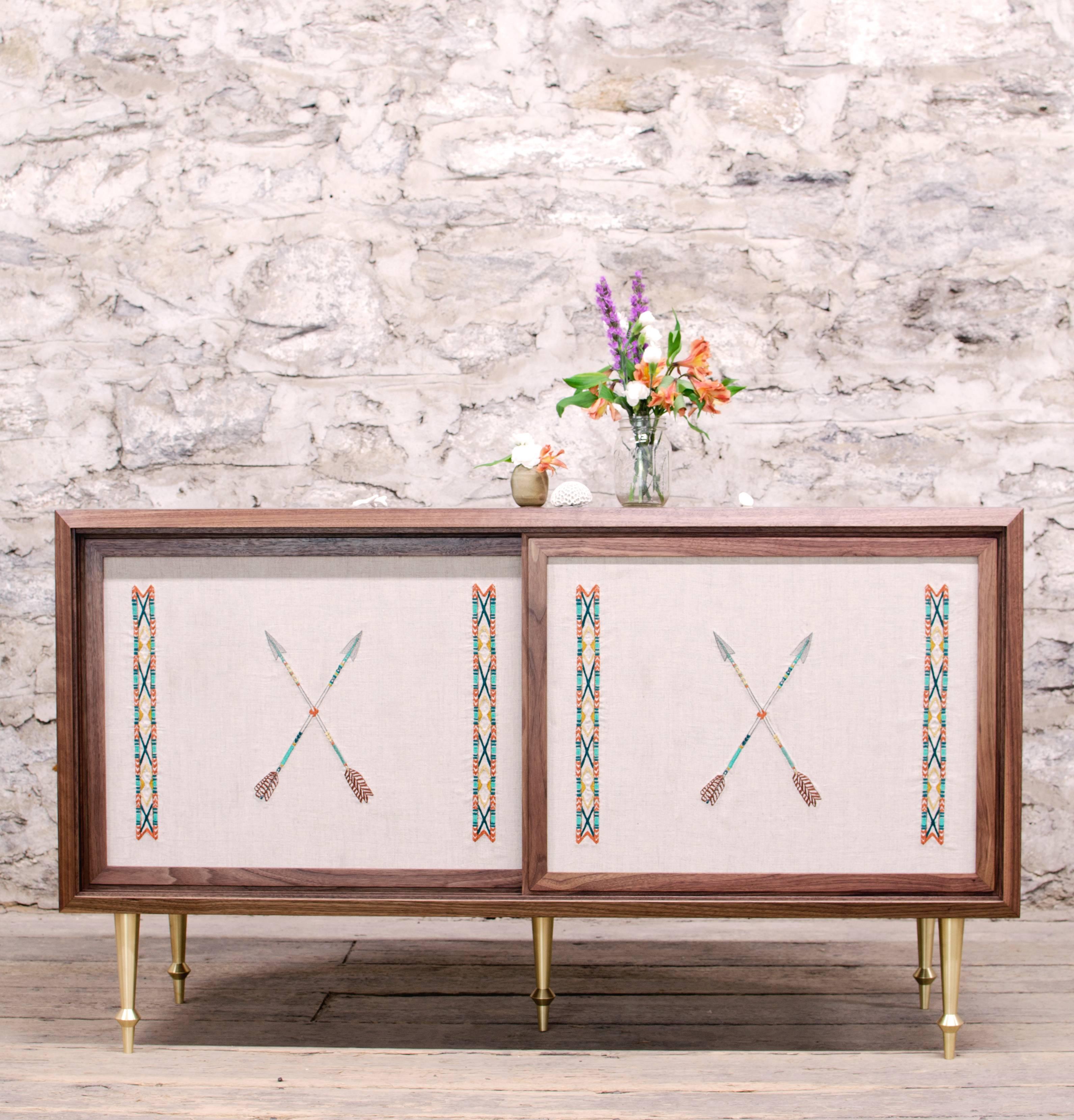 As shown:
Solid walnut with turned brass legs.
Sliding doors with exclusive Coral & Tusk embroidered linen panels.
Oil and wax finish.
Dimensions: 30” H x 52” W x 18” D.
Custom sizing and Coral & Tusk fabric options available.
Offered in a