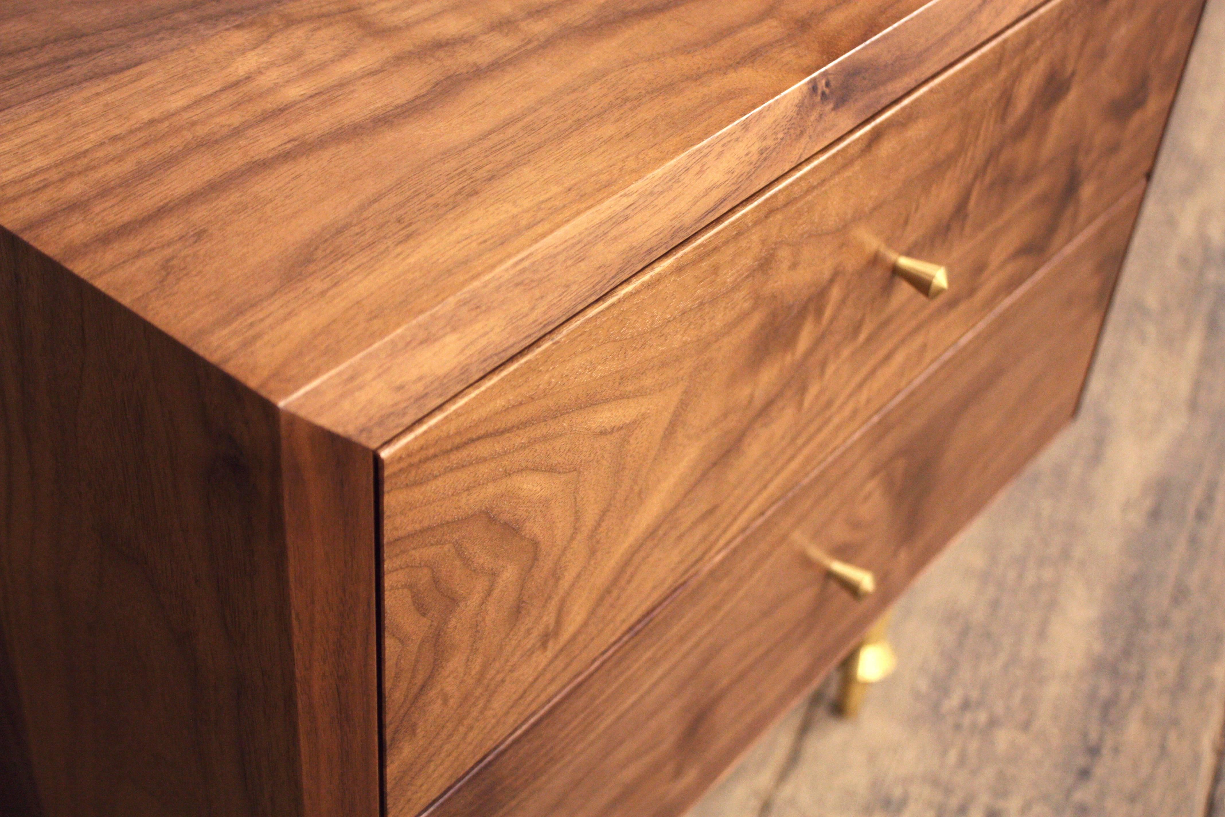 As shown:
Solid walnut with turned brass legs and drawer pulls.
Fabric lined drawers upon request at an additional fee. Hand-rubbed oil finish. Dimensions: 21” H x 21” W x 16” D. 
Custom sizing available.
Offered in a variety of domestic woods