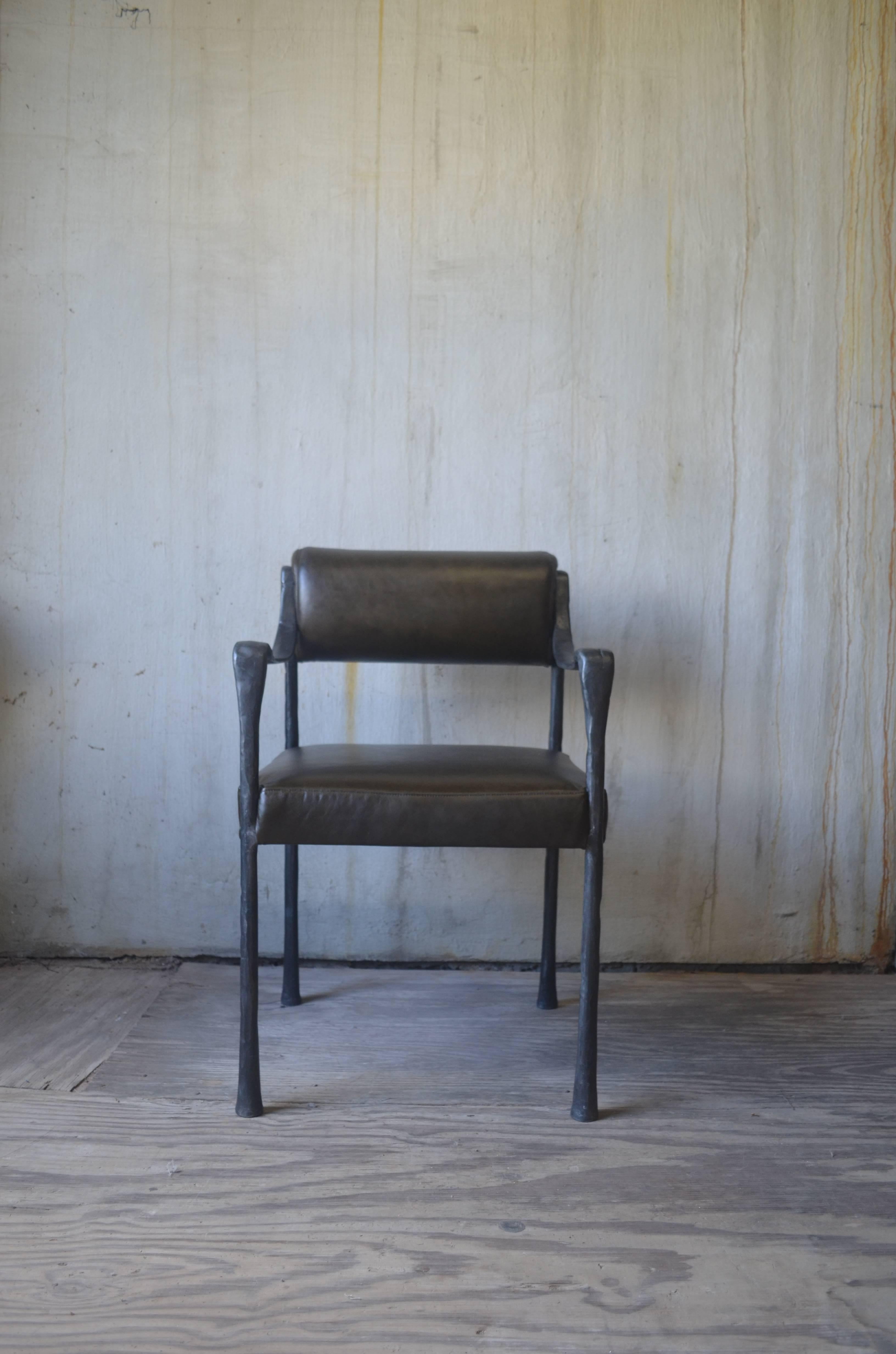 Cast metal frame makes for a sculptural side chair but the weight is also perfect for dining applications. It is available in five frame finishes: Black, polished, white bronze, champagne bronze, and oil-rubbed bronze. Upholstery is COM/COL.