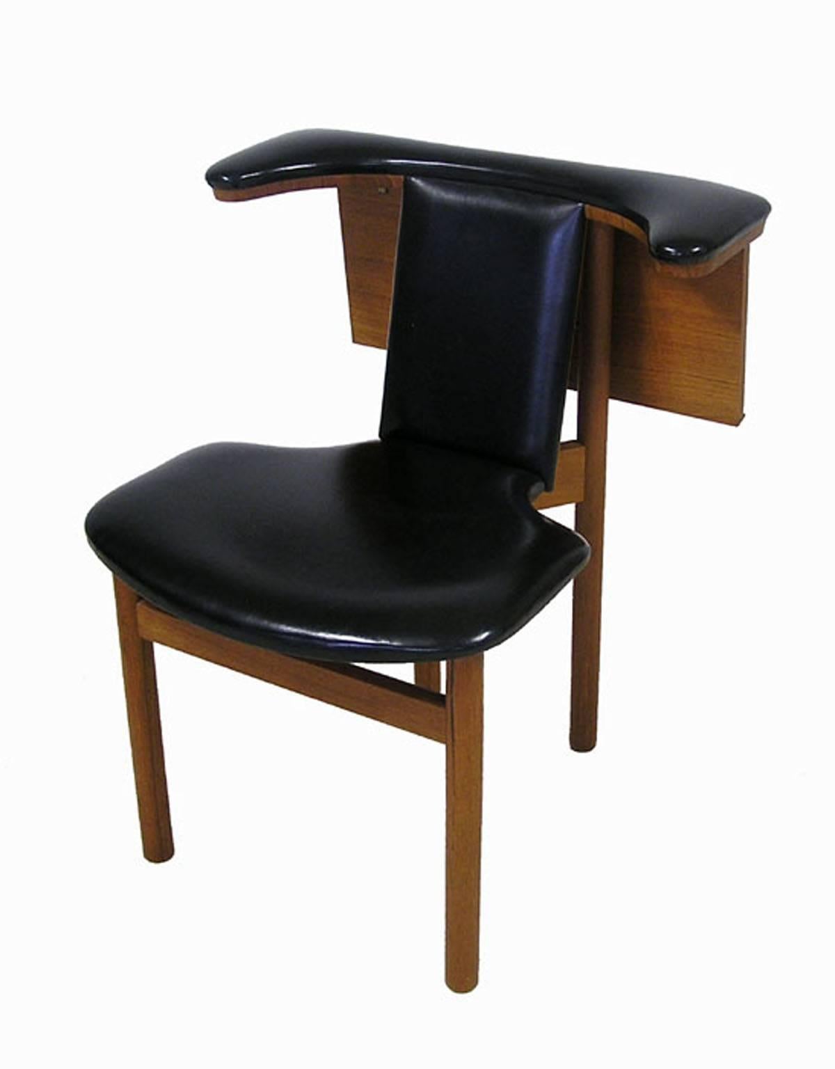 A rare multifunctional chair from the 1950s Danish modern era uniquely crafted to facilitate both forward and reverse use. Designed by Hans Olsen and referred to as the 