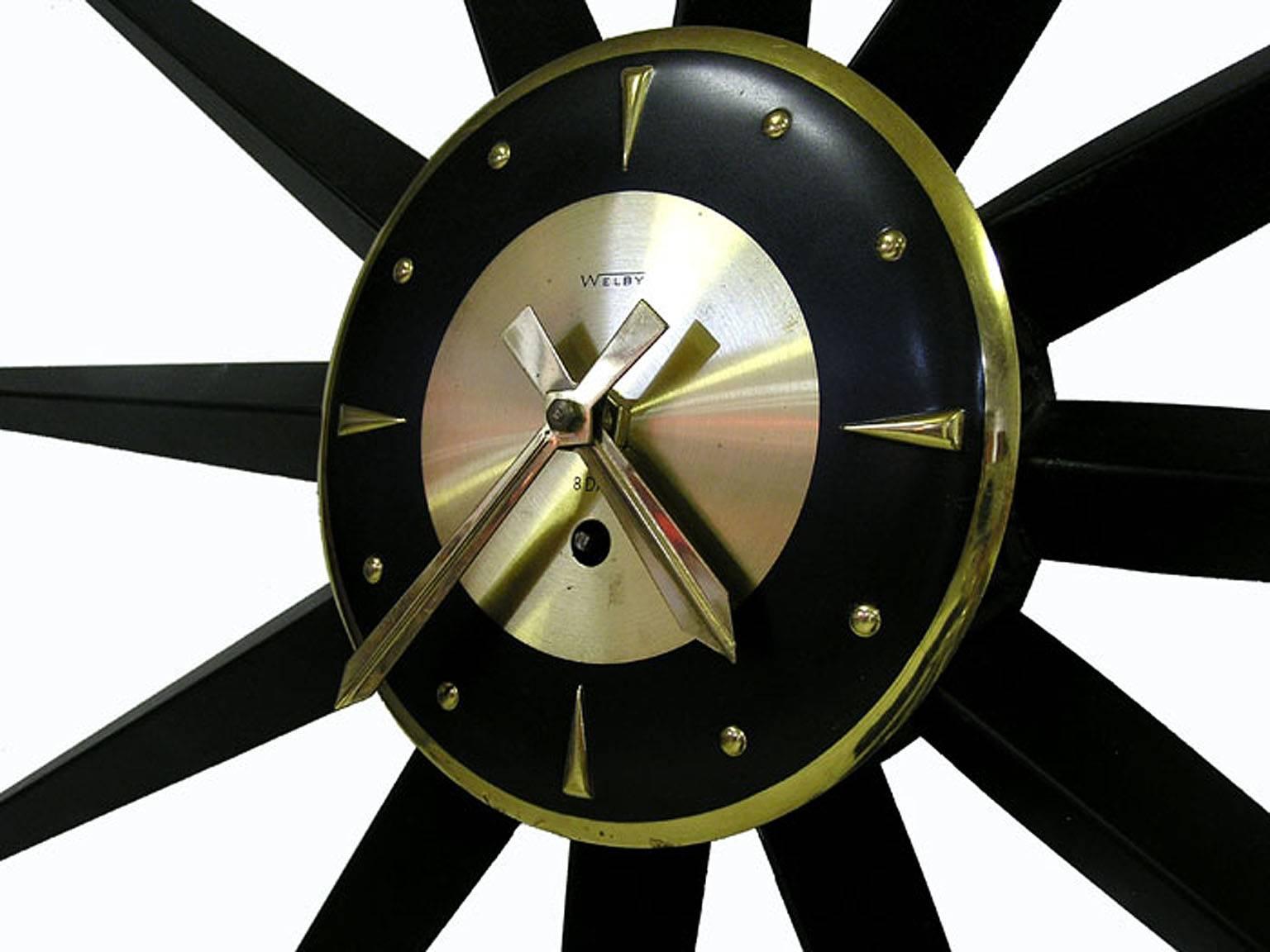 A stunning starburst eight-day wind-up metal wall clock from the 1950s Mid-Century Modern era by Welby of Germany. Clock is in excellent working condition and comes with the original key. Measures 35